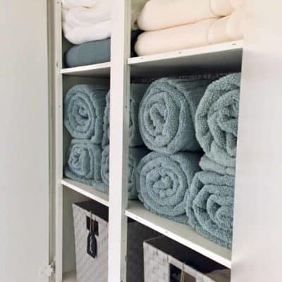 An organized small linen closet.
