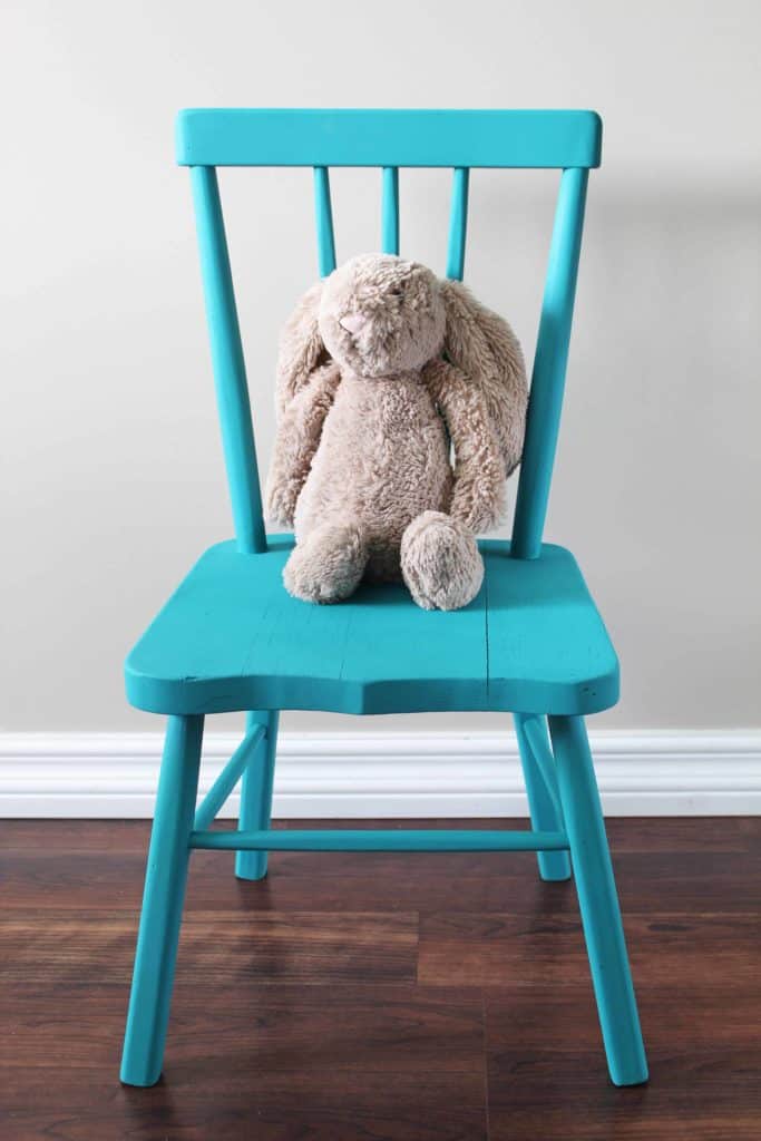 blue chalk painted chair with stuffed jelly cat bunny on it