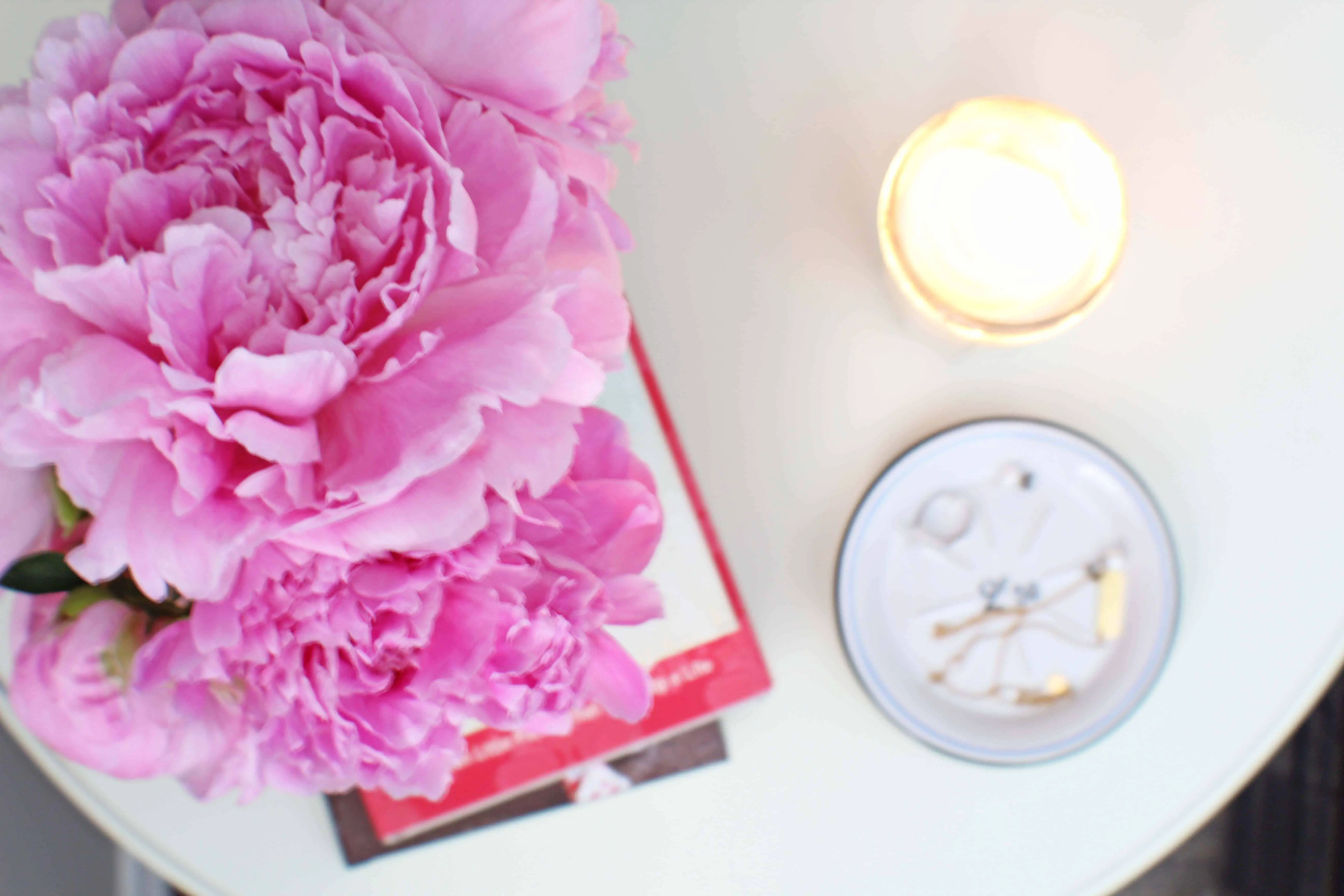 pink peonies, jar candle, pottery barn round bedside table