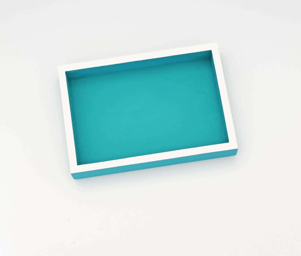 This DIY color block jewelry tray is an easy way to corral small items while adding a pop of color to your home.  #jewelrytray #diyjewelrytray #jewelrybox #catchall #colorful #turquoise #aqua #easydiyprojects #acrylicpaint #jewelryorganization #jewelryhack