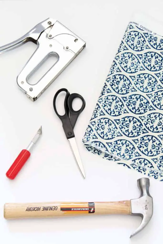 block print fabric, scissors, hammer, and exact knife