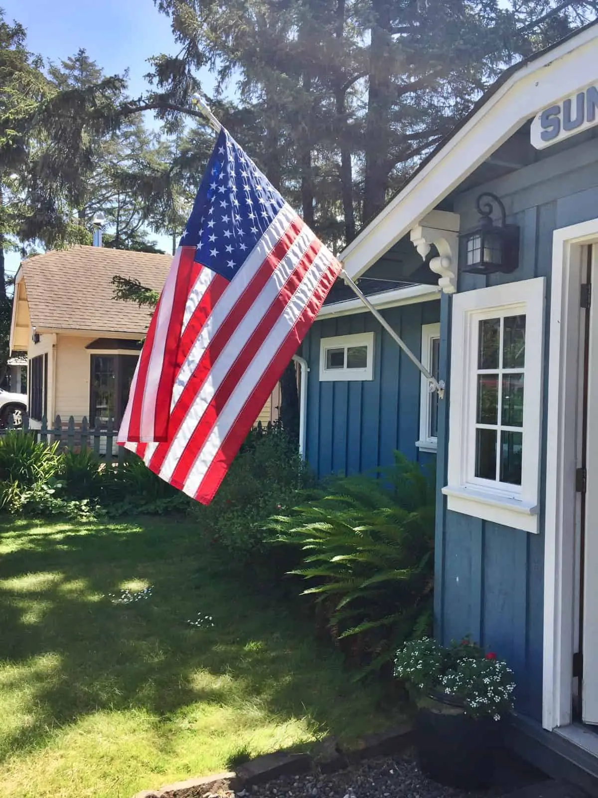 blue beach house with american flag