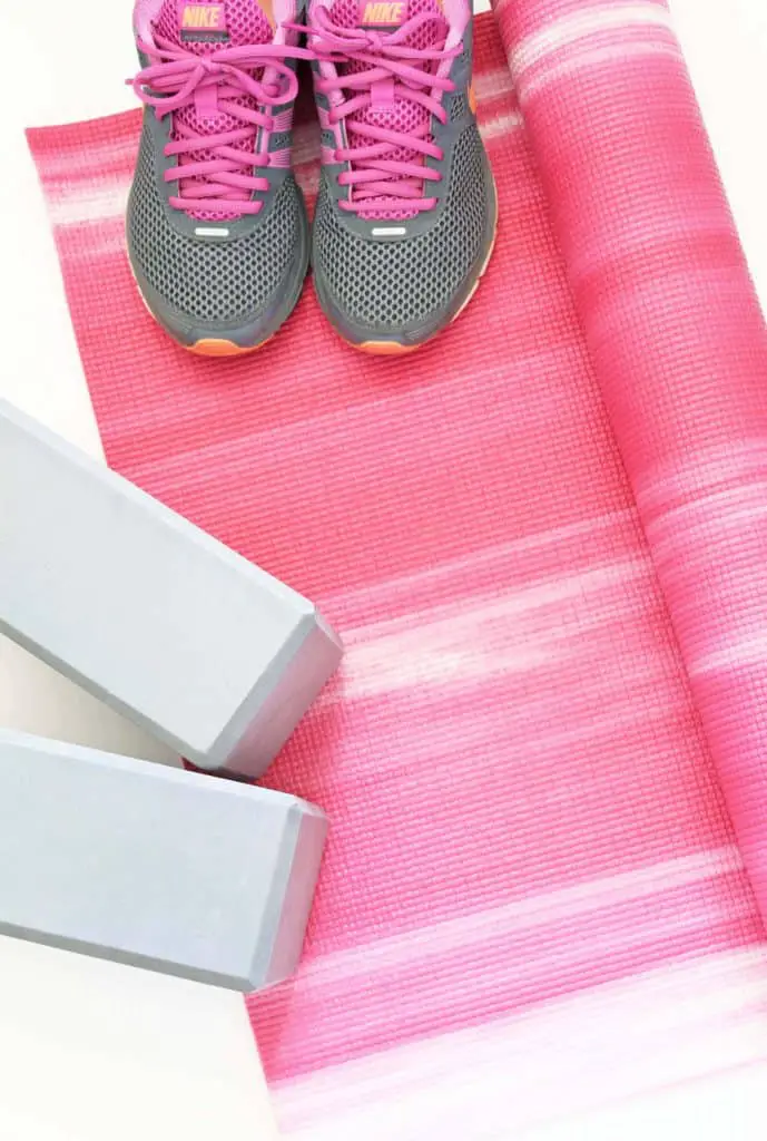 pink yoga mat, purple nike sneakers, gray yoga blocks