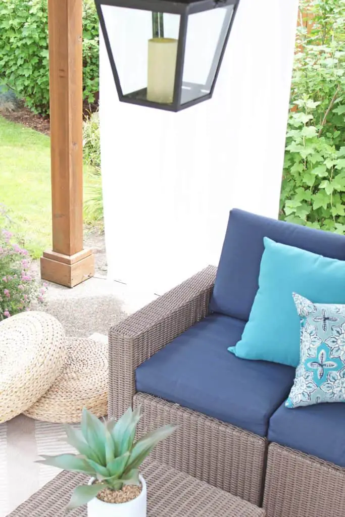Summer is just around the corner, which means longer days and more outdoor time. Are you stuck on where to start with your outdoor space? Try these 5 simple patio makeover ideas.  #summerpatio #outdoorspace #outdoorlanterns #pergola #wickersectional #outdoorcurtains #outdoorrug #summerentertaining #outdoorlivingroom #bluedecor #aquadecor #backpatio #backyard #backdeck #smallyard