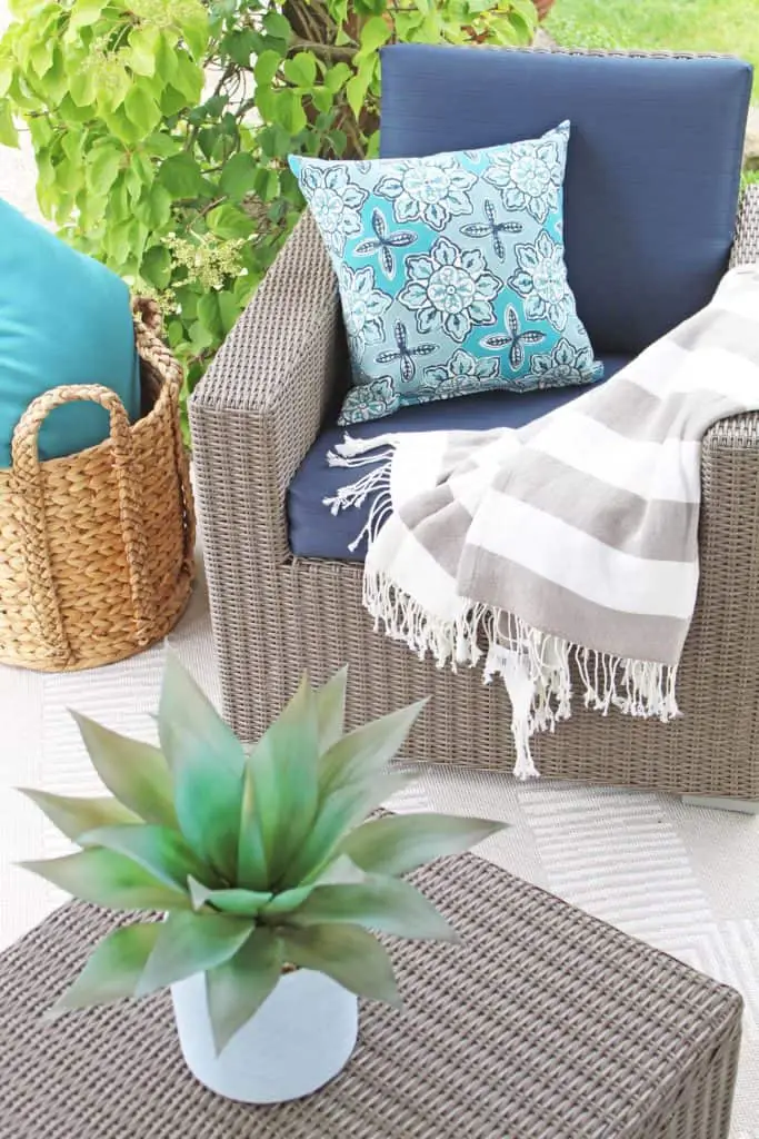 Summer is just around the corner, which means longer days and more outdoor time. Are you stuck on where to start with your outdoor space? Try these 5 simple patio makeover ideas.  #summerpatio #outdoorspace #outdoorlanterns #pergola #wickersectional #outdoorcurtains #outdoorrug #summerentertaining #outdoorlivingroom #bluedecor #aquadecor #backpatio #backyard #backdeck #smallyard