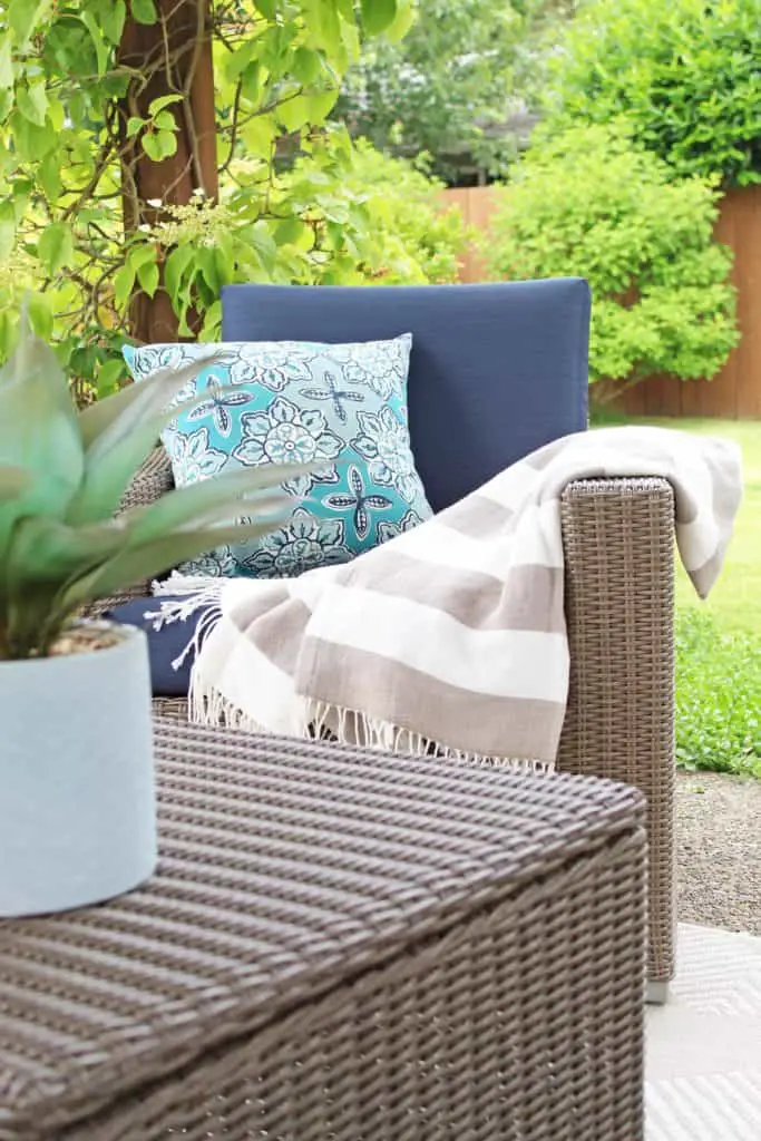 Summer is just around the corner, which means longer days and more outdoor time. Are you stuck on where to start with your outdoor space? Try these 5 simple patio makeover ideas.  #summerpatio #outdoorspace #outdoorlanterns #pergola #wickersectional #outdoorcurtains #outdoorrug #summerentertaining #outdoorlivingroom #bluedecor #aquadecor #backpatio #backyard #backdeck #smallyard