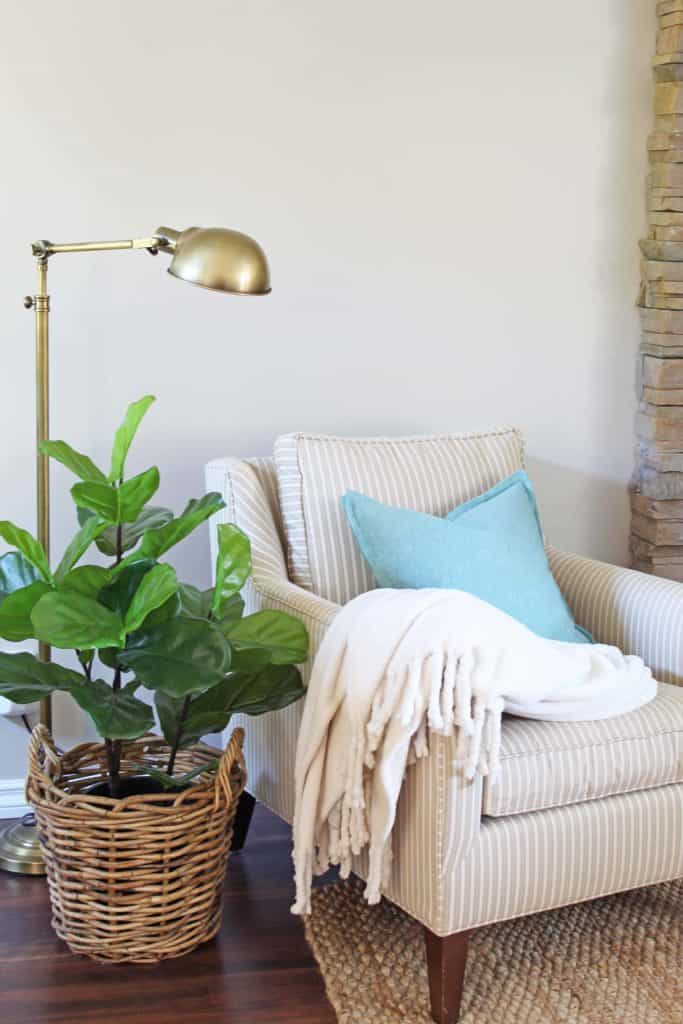 pottery barn chair with brass lamp and fiddle leaf fig