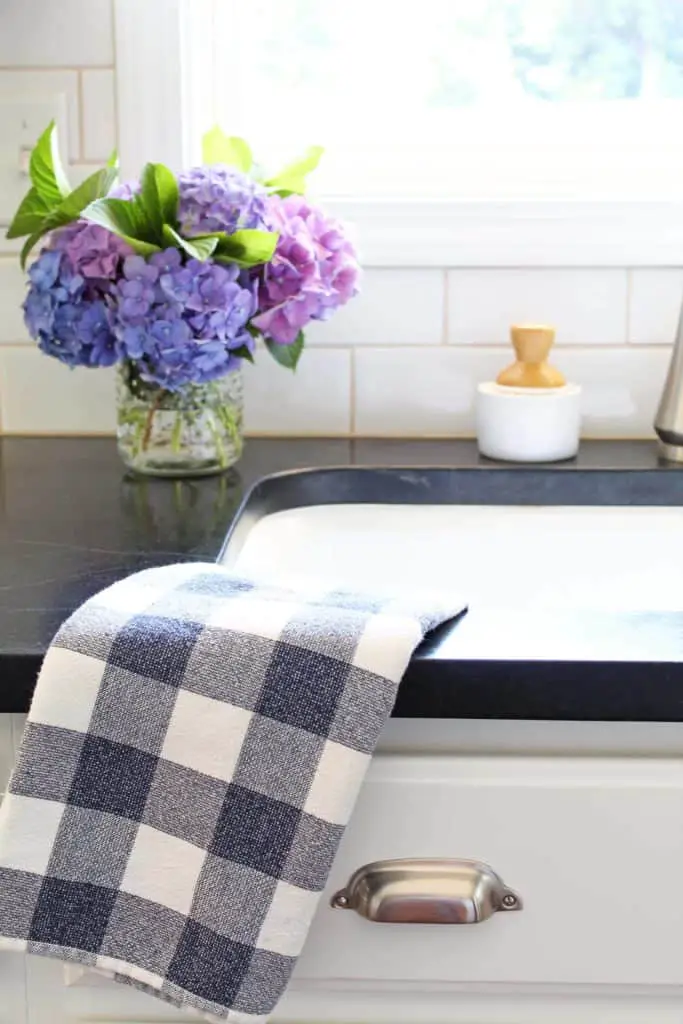 farmhouse kitchen sink with soapstone counter and hydrangeas