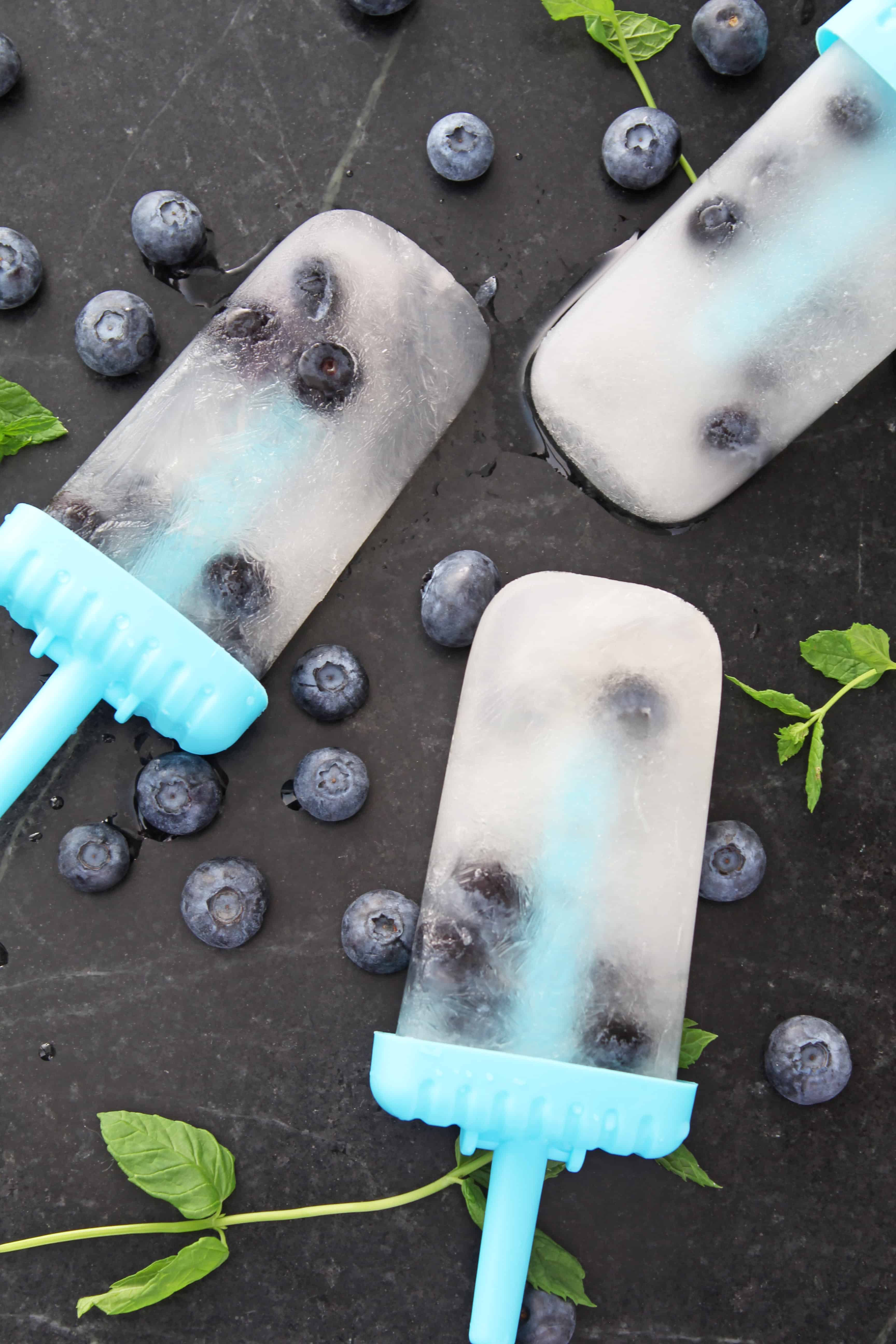 homemade blueberry lemonade popsicles and mint leaves