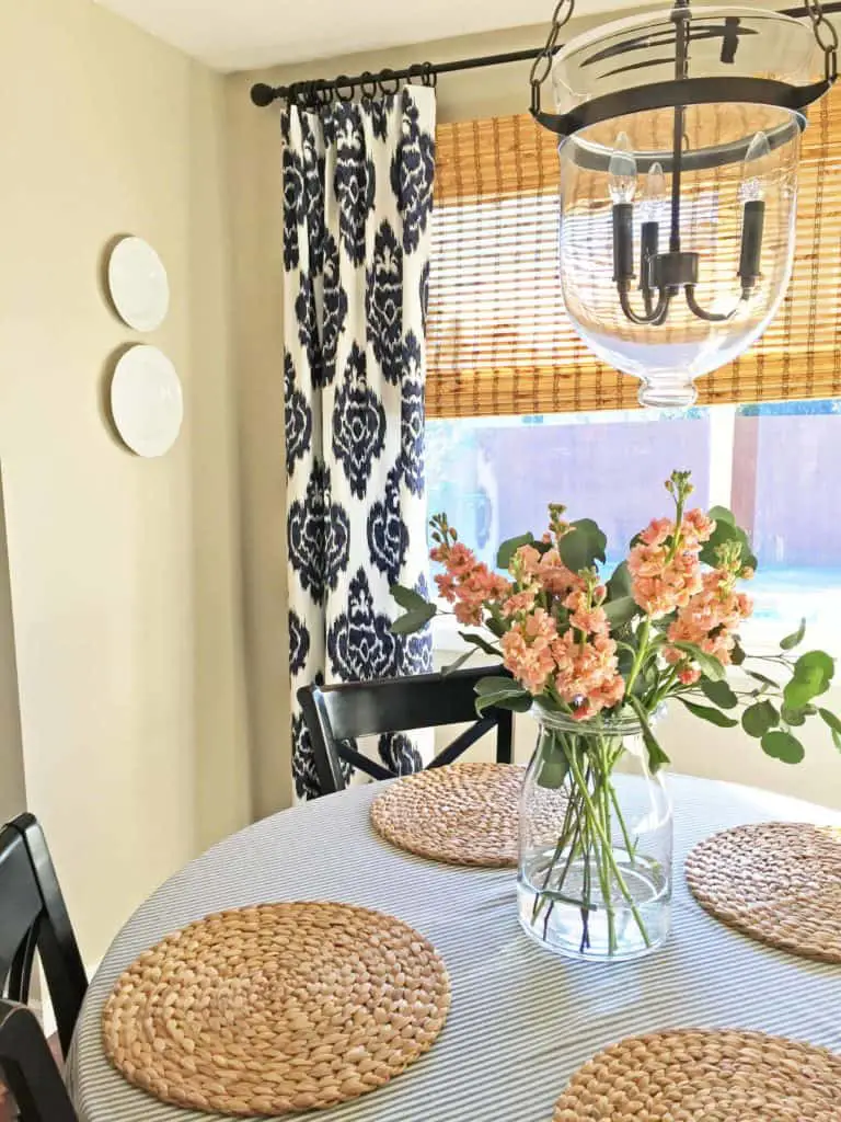 dining room with ikat curtains and woven blinds