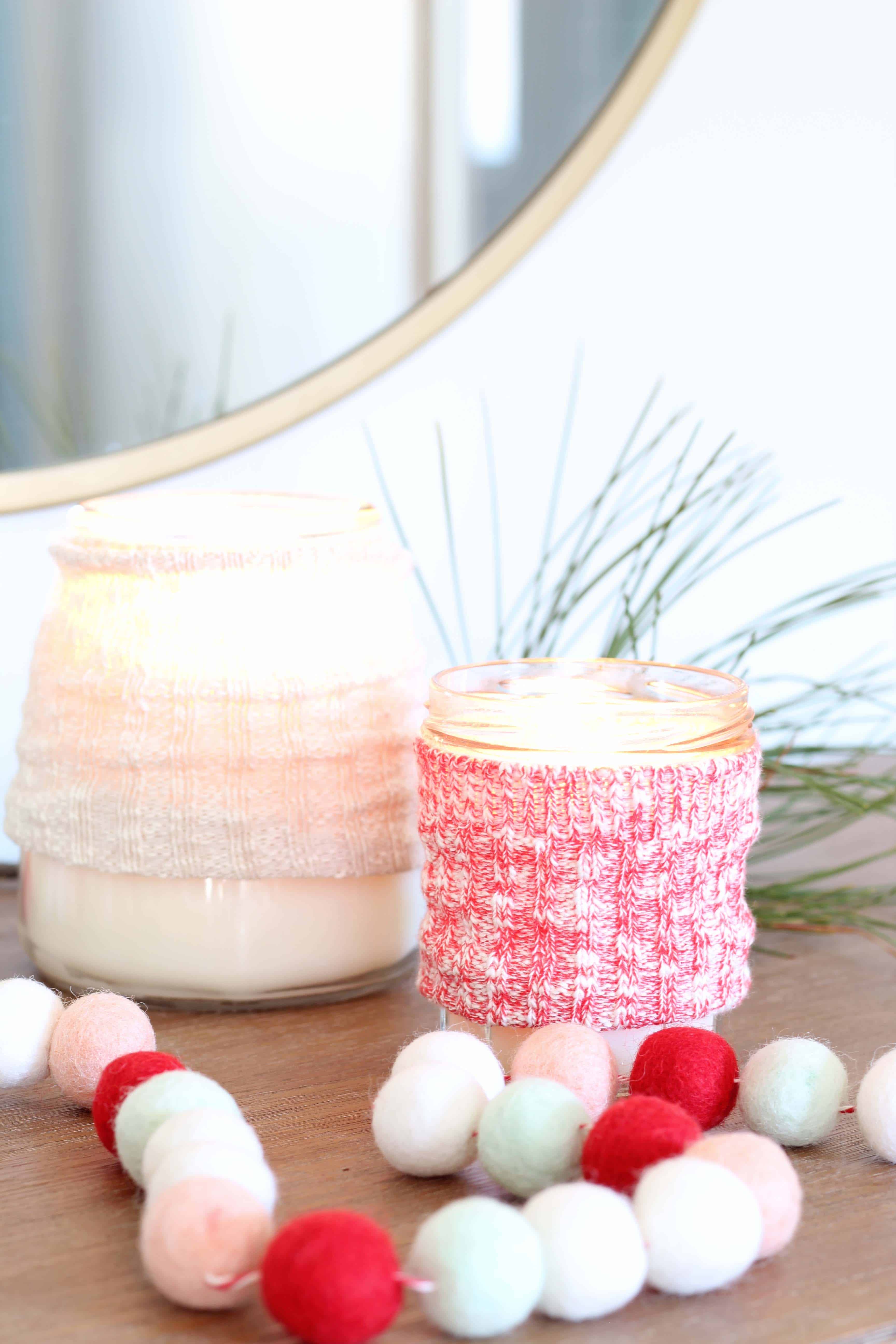 candles with sweater cozy and pom pom garland