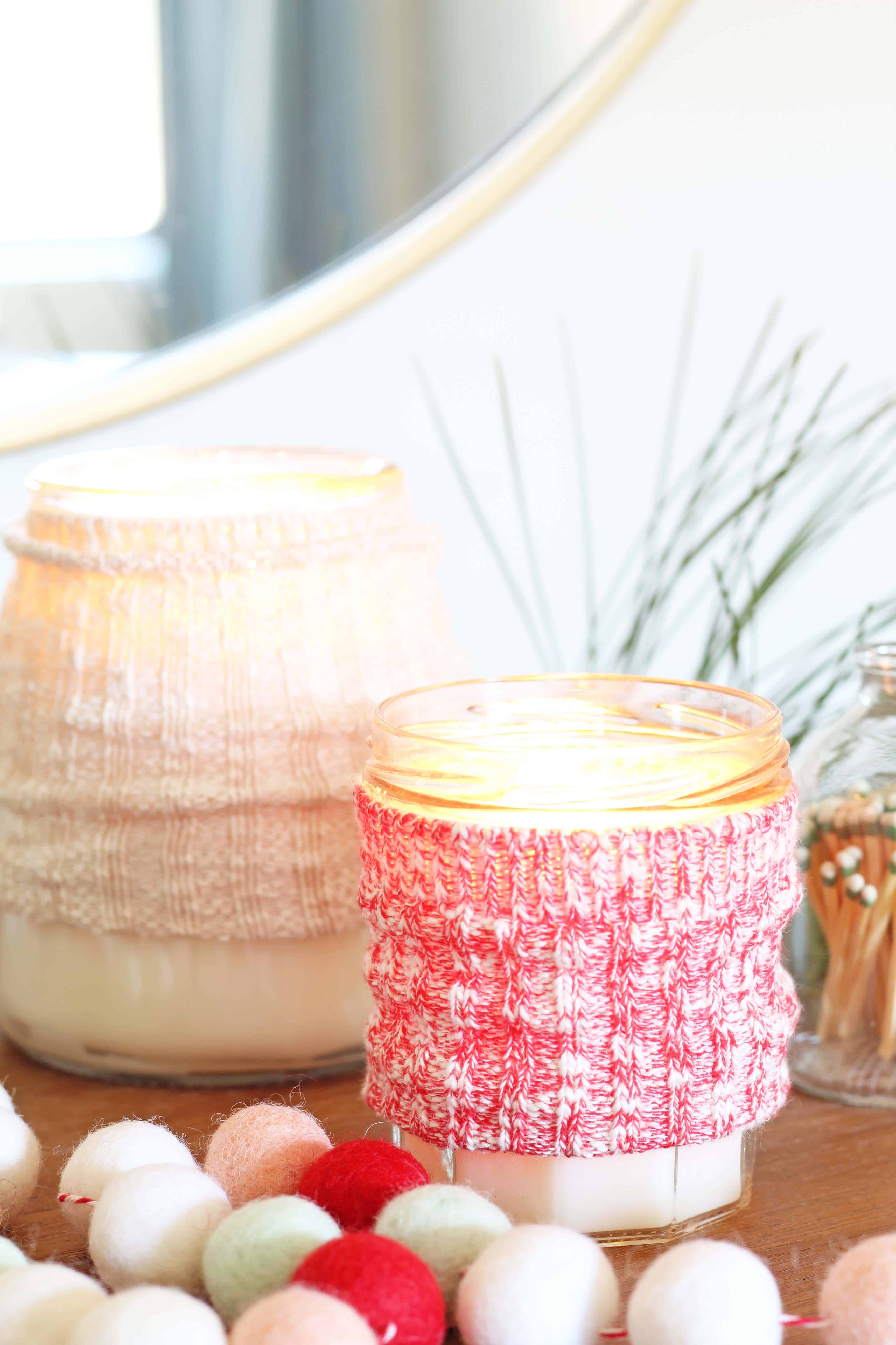 candles with sweater cozy and pom pom garland