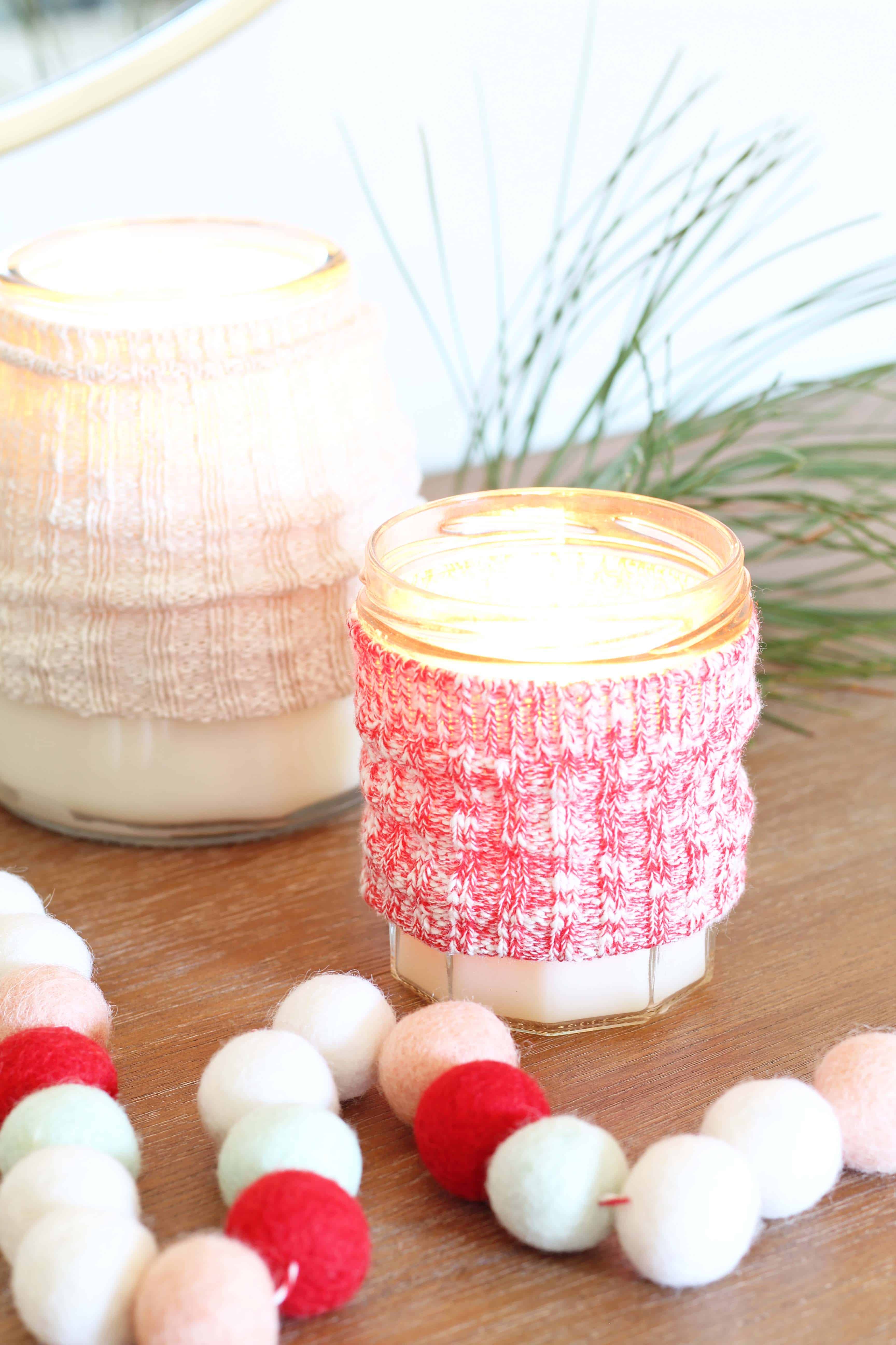 candles with sweater cozy and pom pom garland