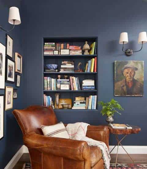 Leather reading chair in room with navy blue walls