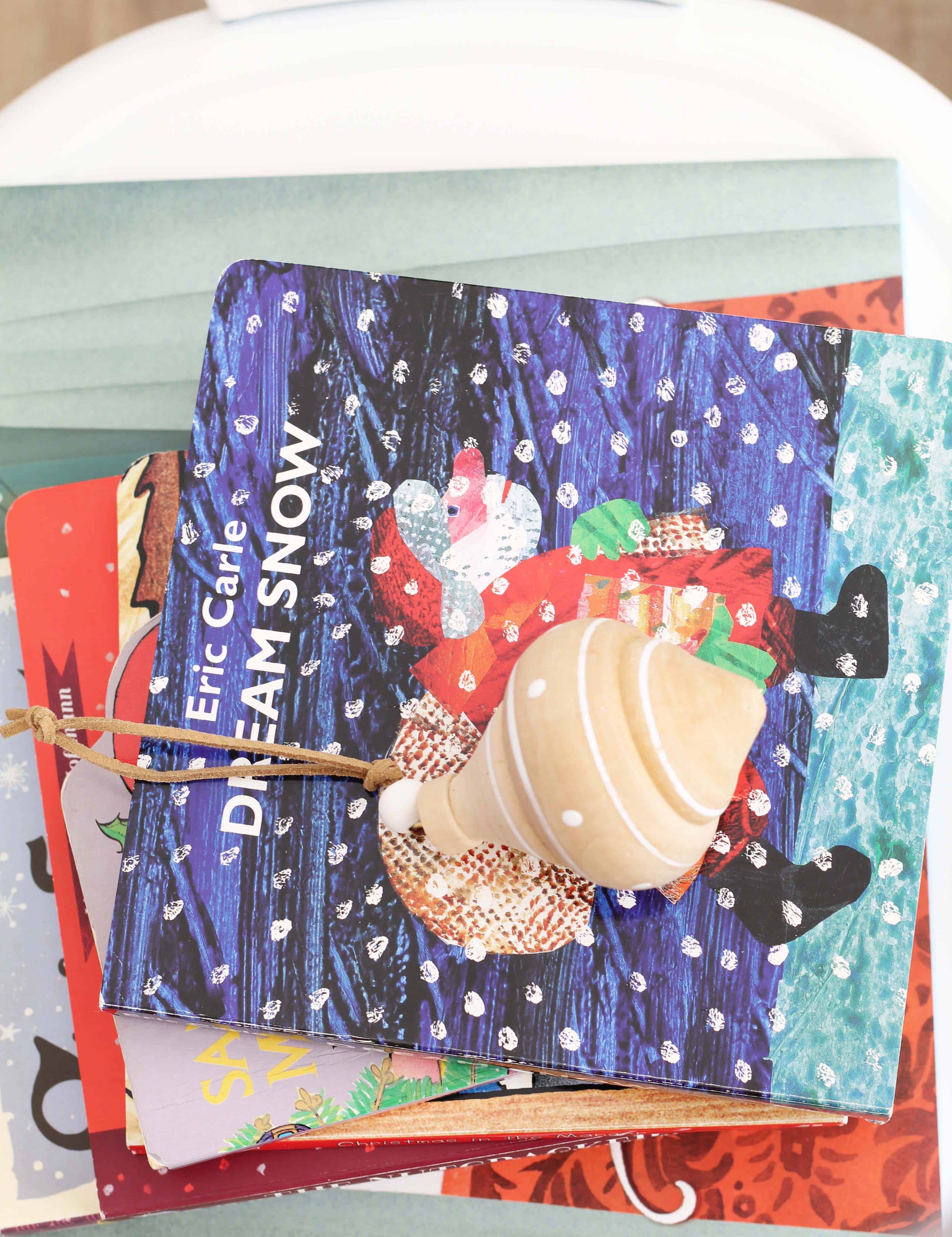 stack of children's christmas books with ornament