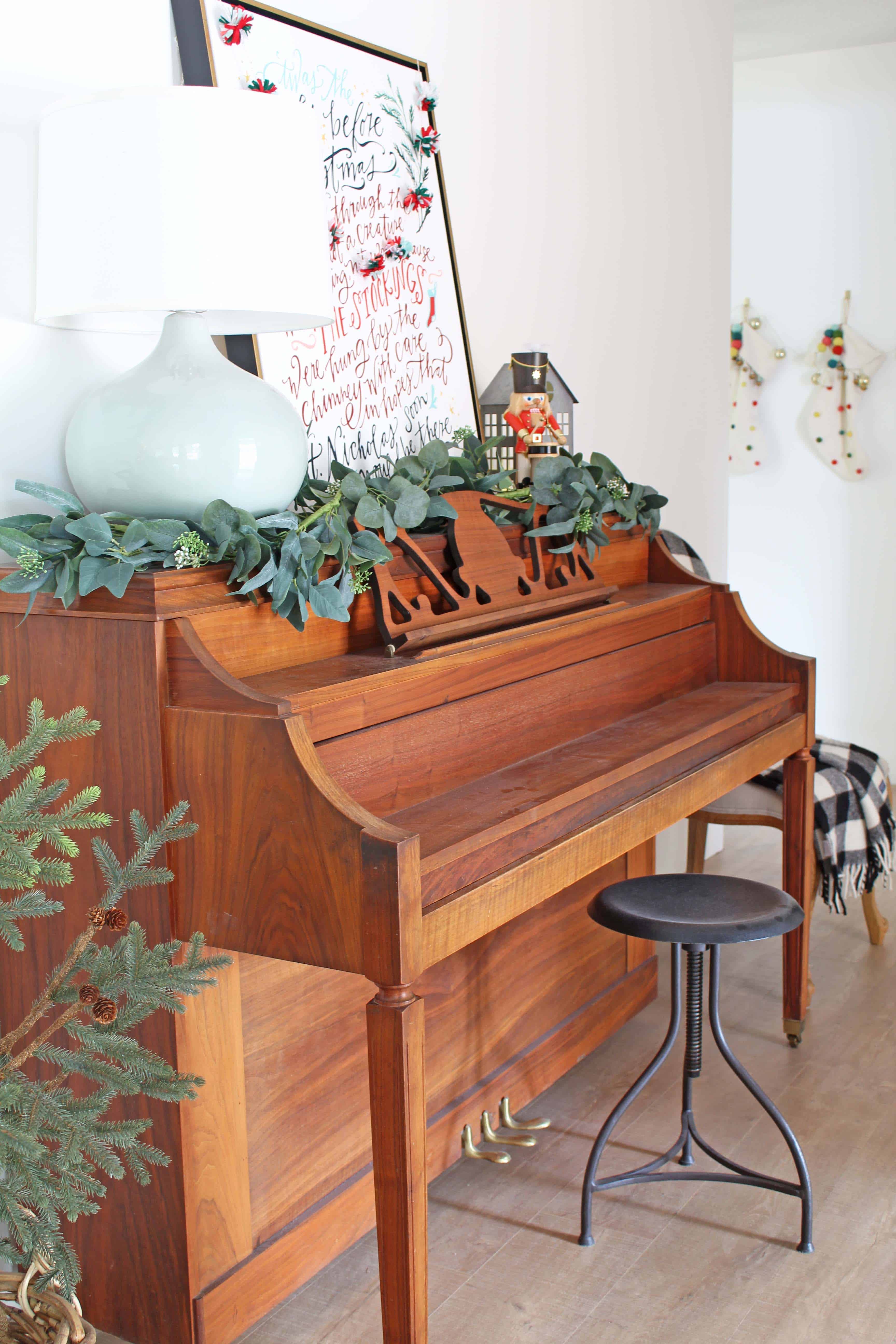 christmas piano with nutcracker and village house