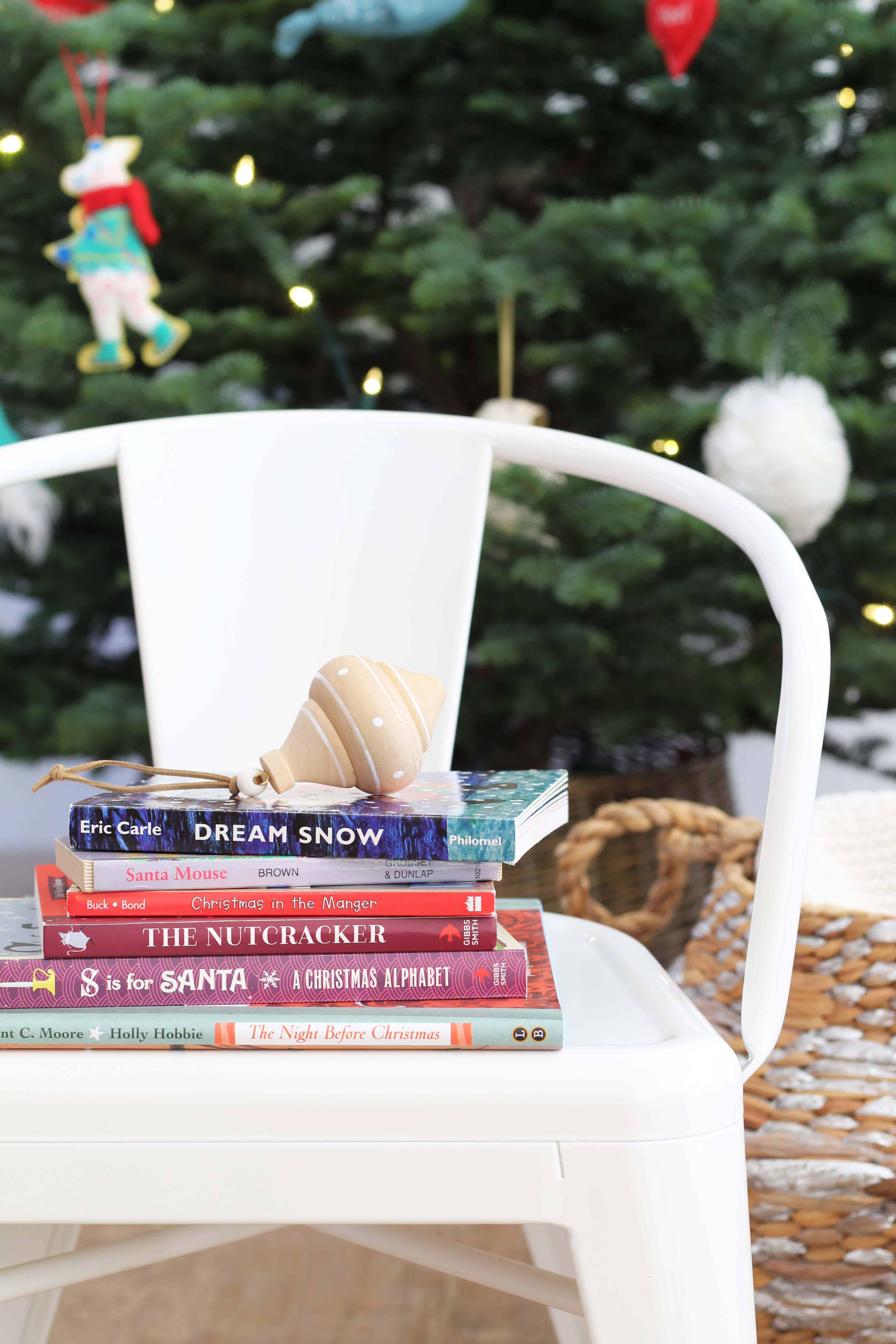 stack of children's christmas books with ornament