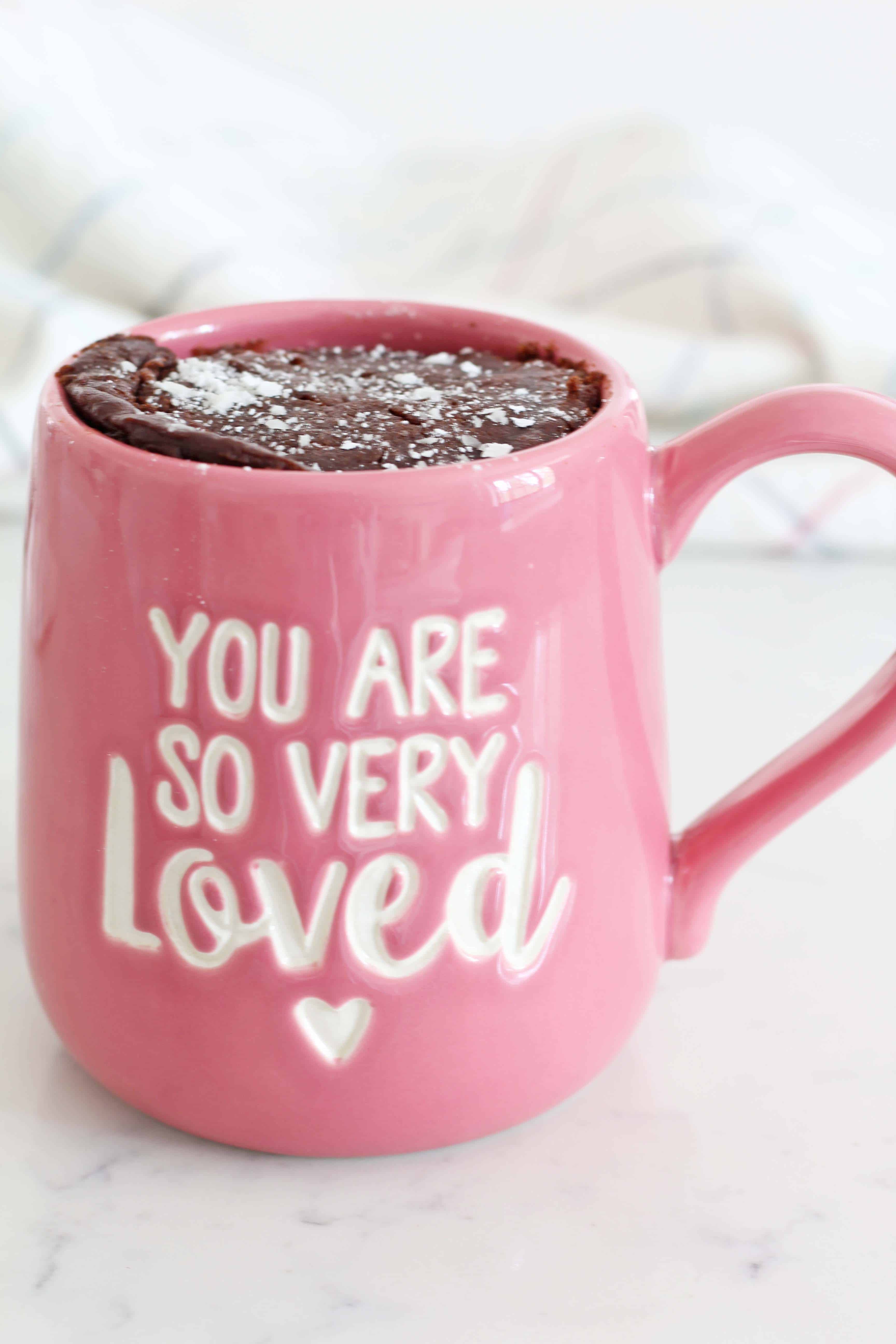 our name is mud mug, chocolate cake in a pink coffee mug