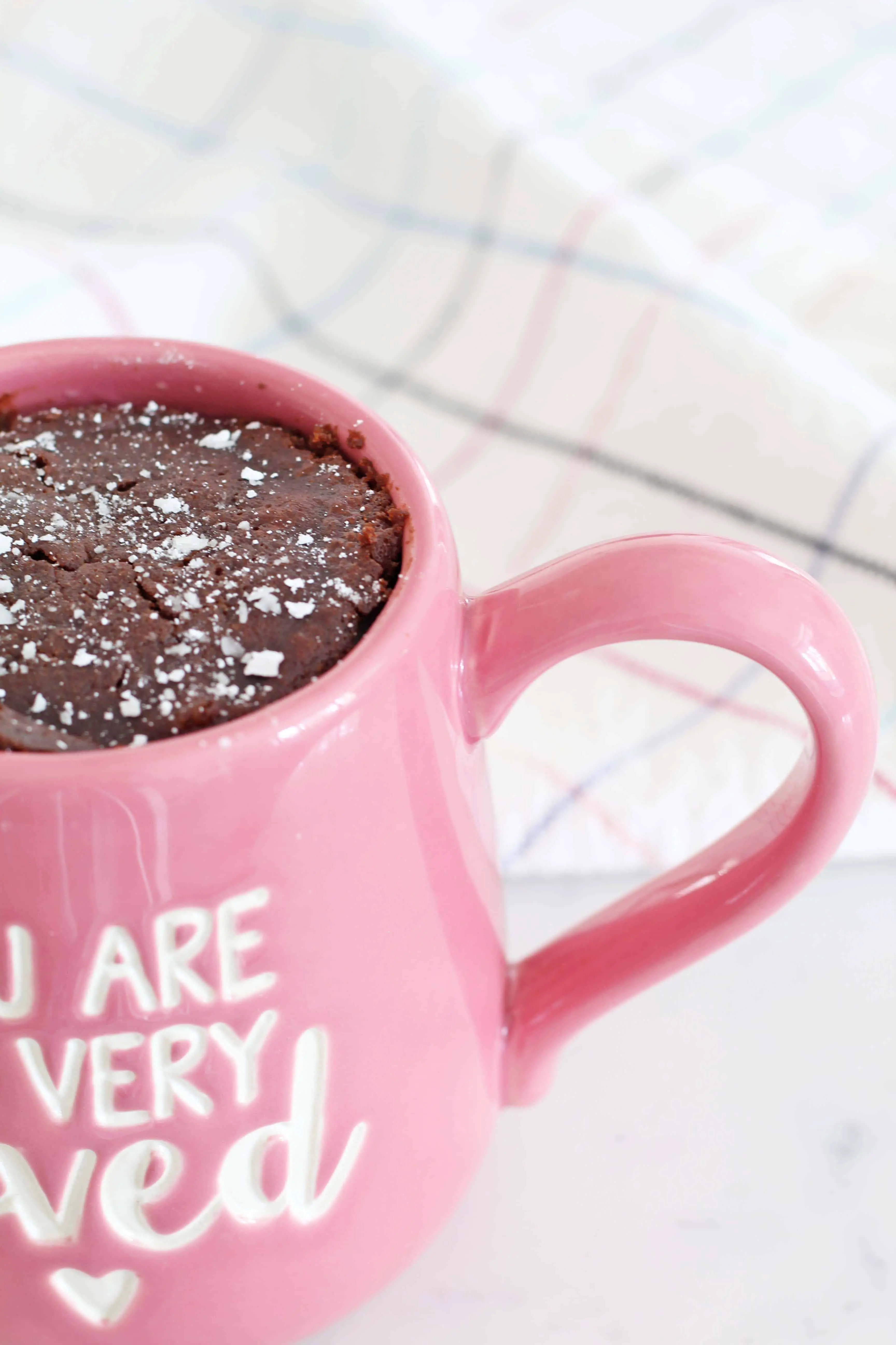 our name is mud mug, chocolate cake in a pink coffee mug