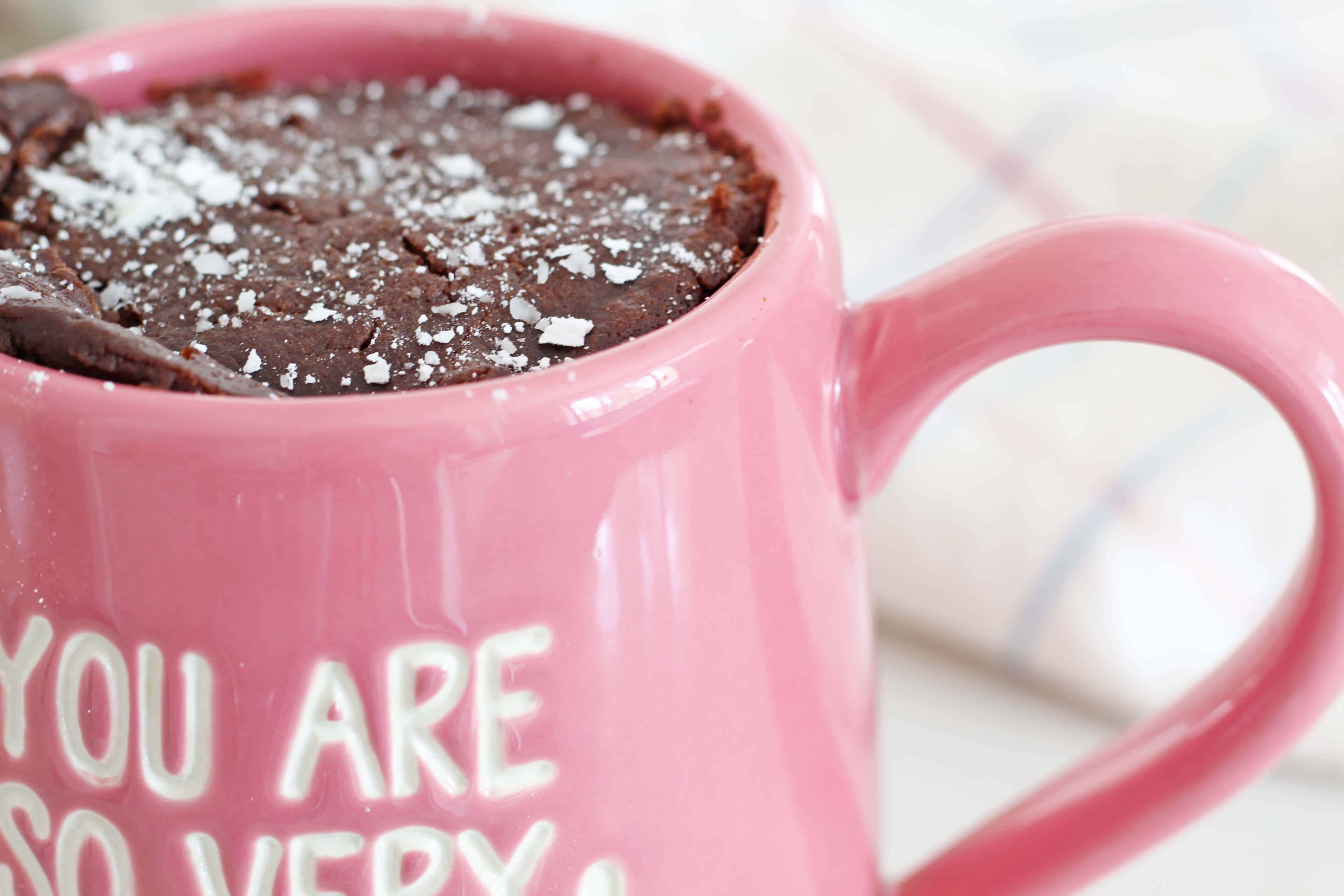 our name is mud mug, chocolate cake in a pink coffee mug