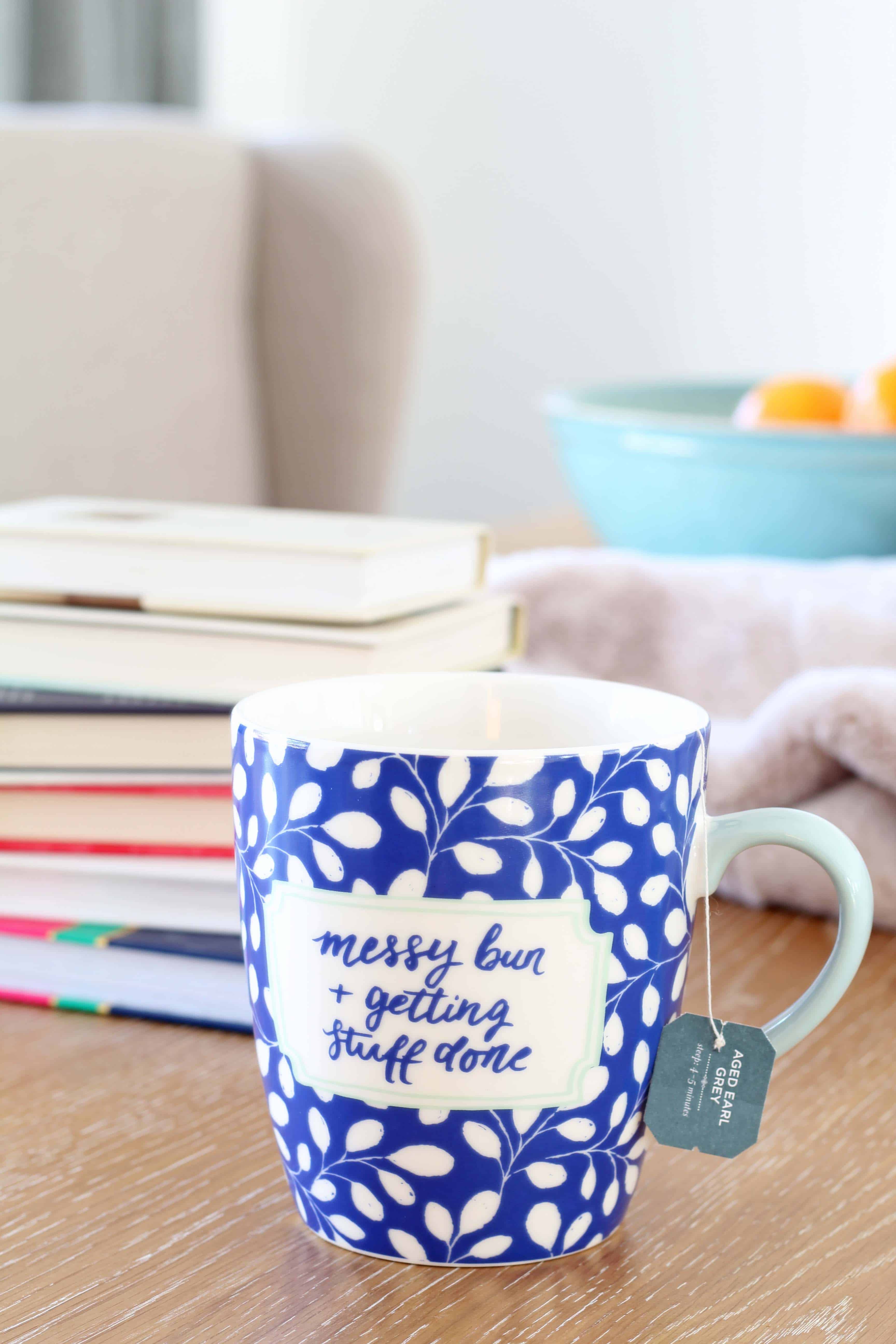 coffee mug with tea bag and stack of books