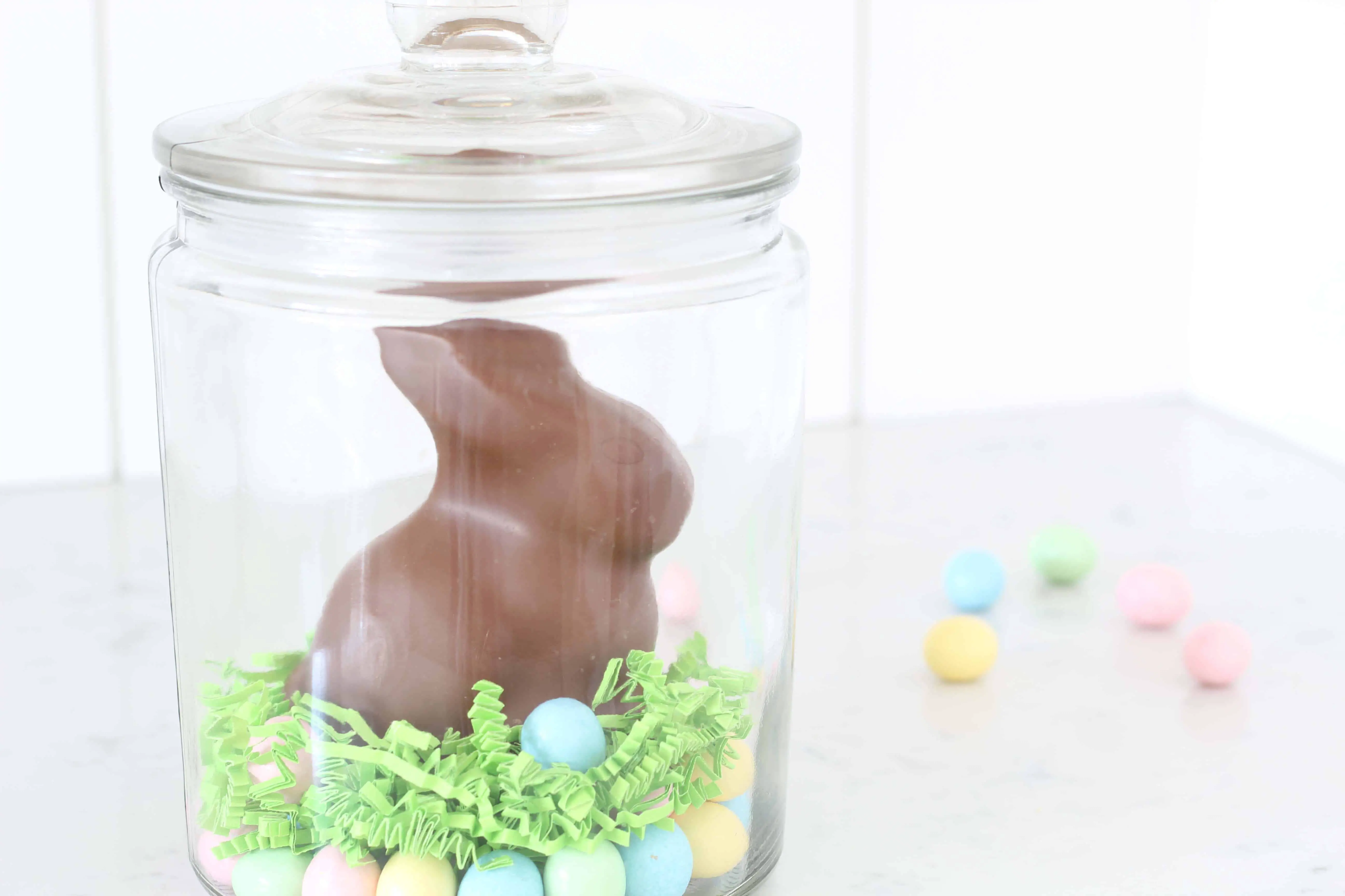 chocolate easter bunny in glass jar withl egg candy 