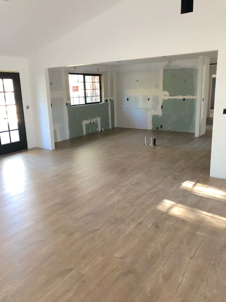 gutted kitchen space with natural wood flooring