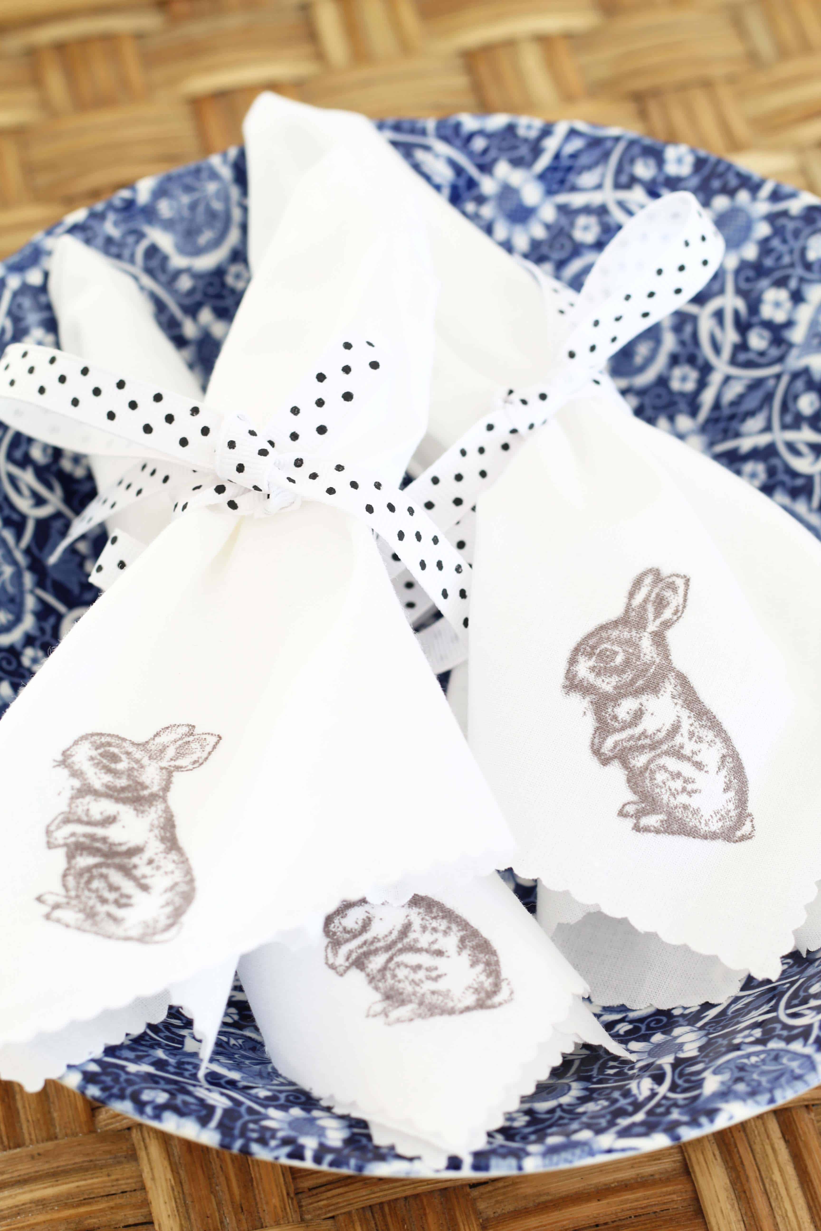 hand stamped easter bunny napkins in blue transfer ware bowl and black and white polka dot ribbon