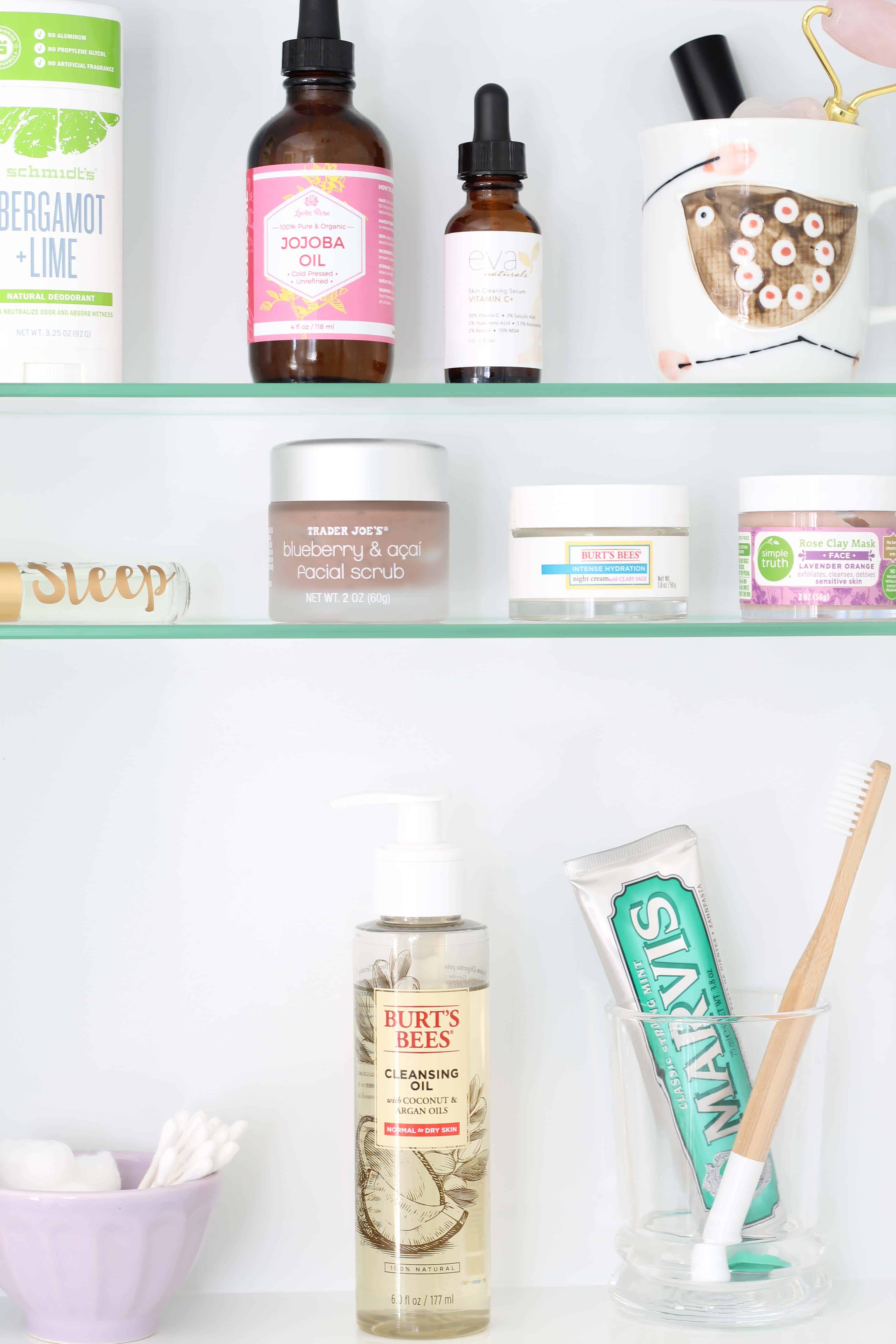 recessed medicine cabinet with marvins toothpaste, wood toothbrush, anthropologie mini latte bowl