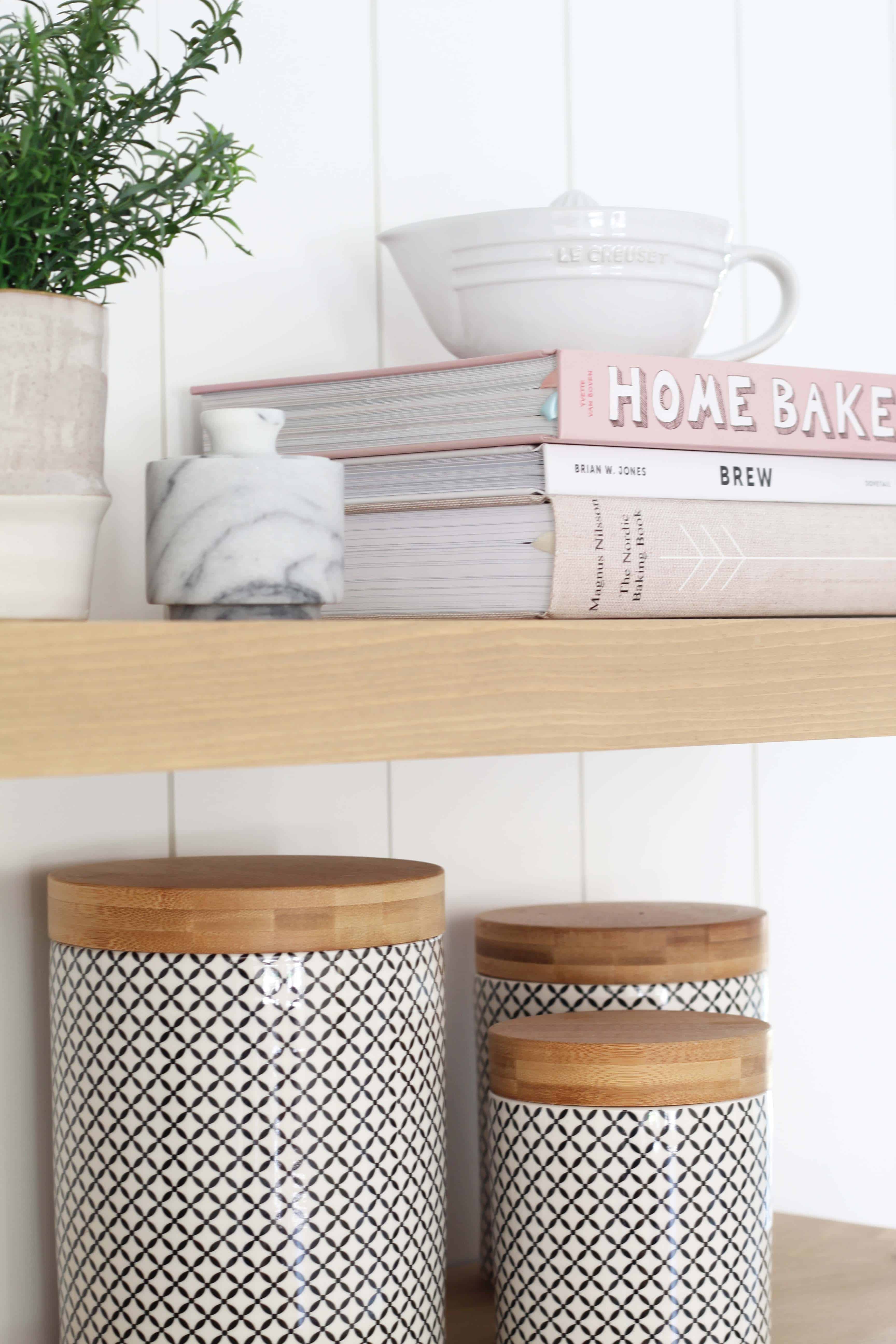 modern farmhouse kitchen with white vertical shiplap backsplash and open shelving, international concepts black lattice canisters, marble salt cellar, le crueset juicer