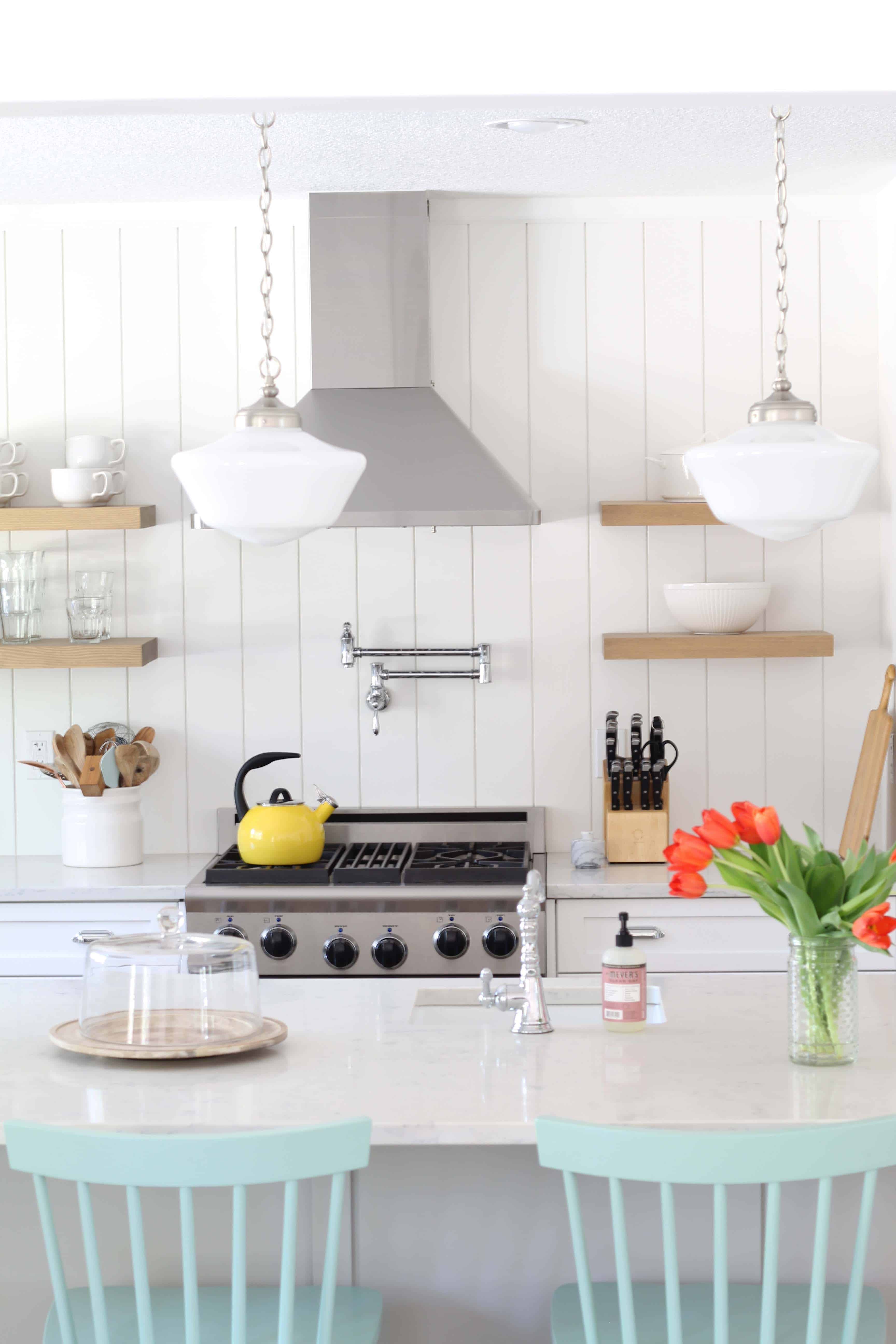 modern farmhouse kitchen with white vertical shiplap backsplash and open shelving