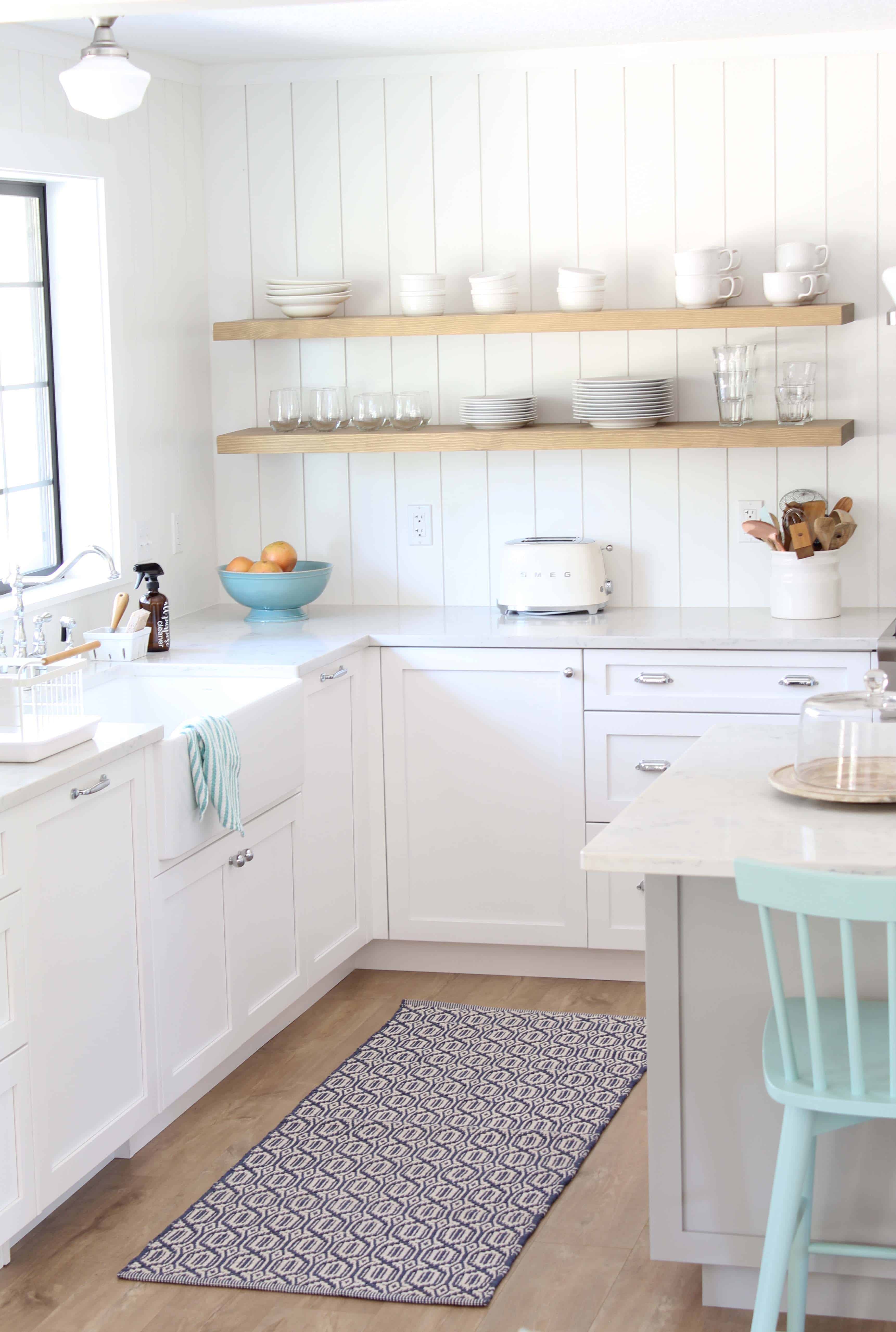 modern farmhouse kitchen with white vertical shiplap backsplash and open shelving