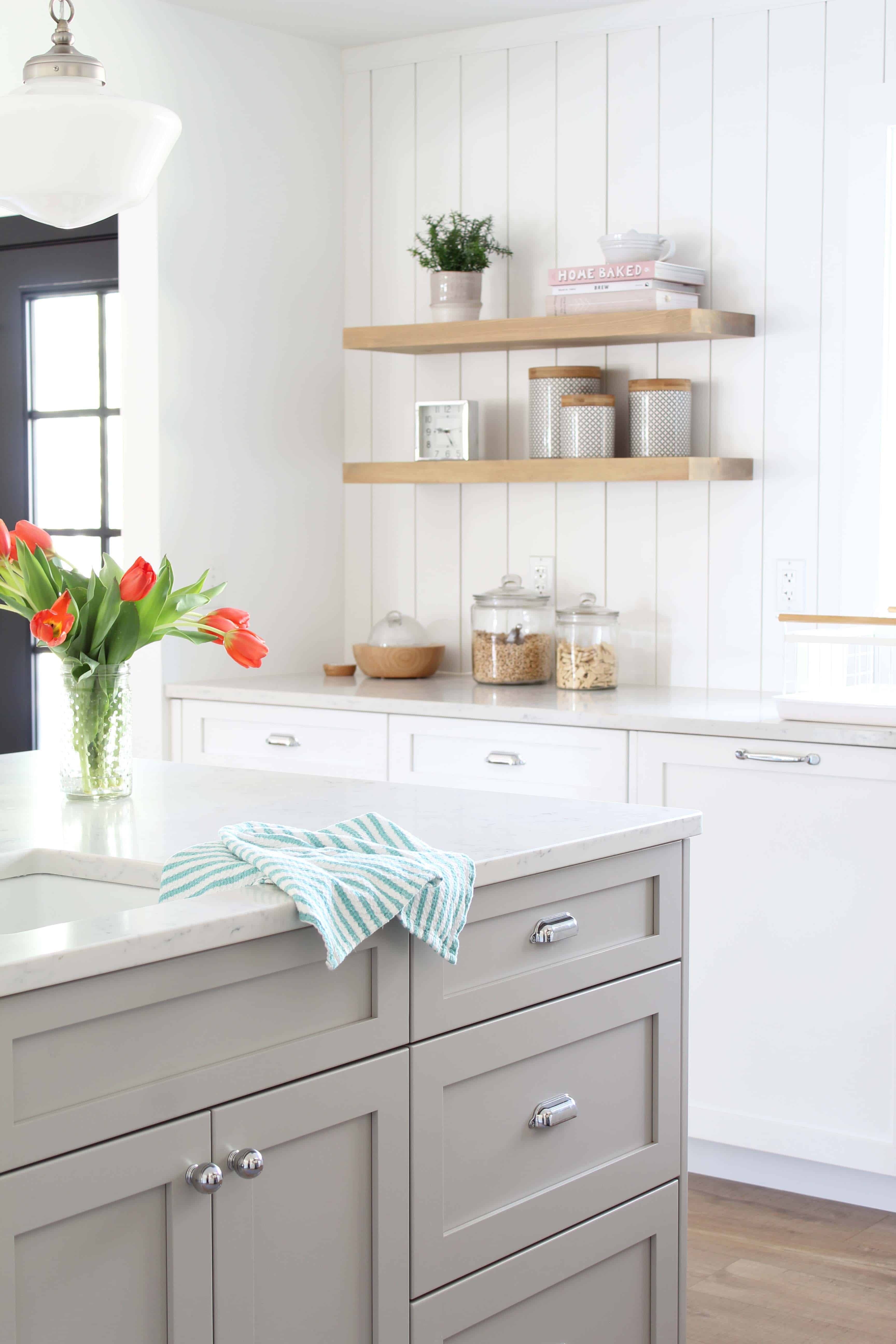 modern farmhouse kitchen with white vertical shiplap backsplash and open shelving