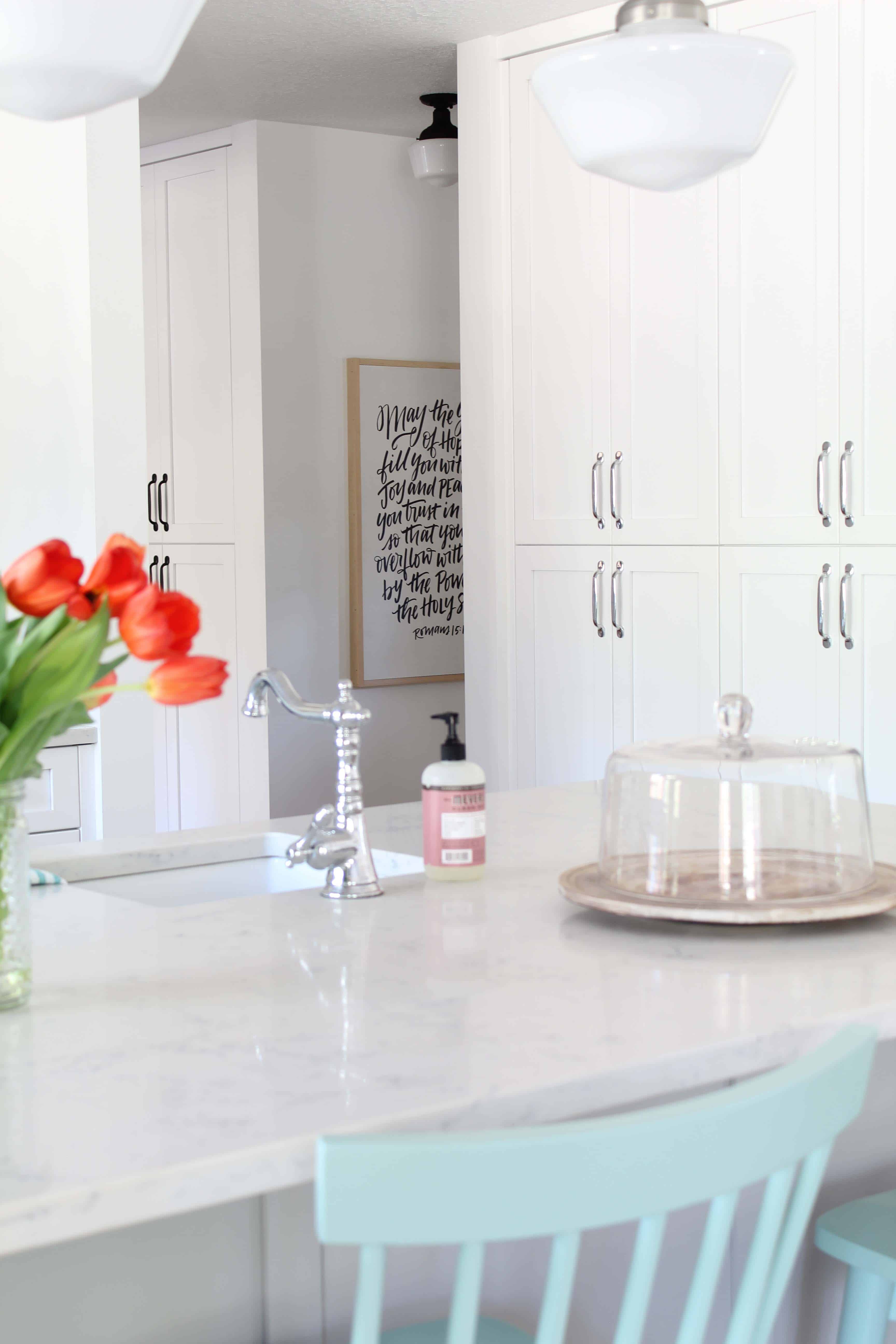 modern farmhouse kitchen with white vertical shiplap backsplash and open shelving and scripture art