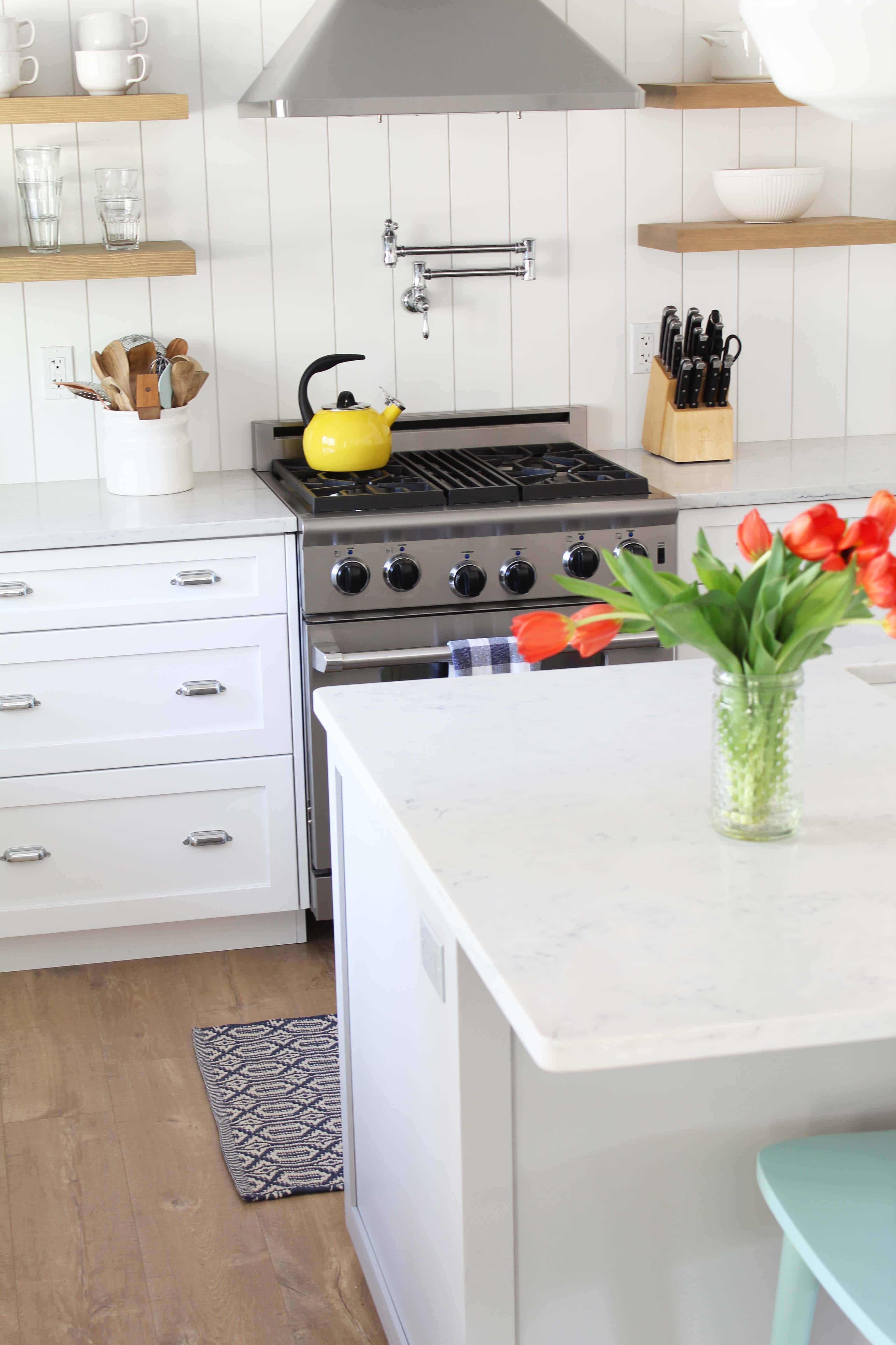 modern farmhouse kitchen with white vertical shiplap backsplash and open shelving