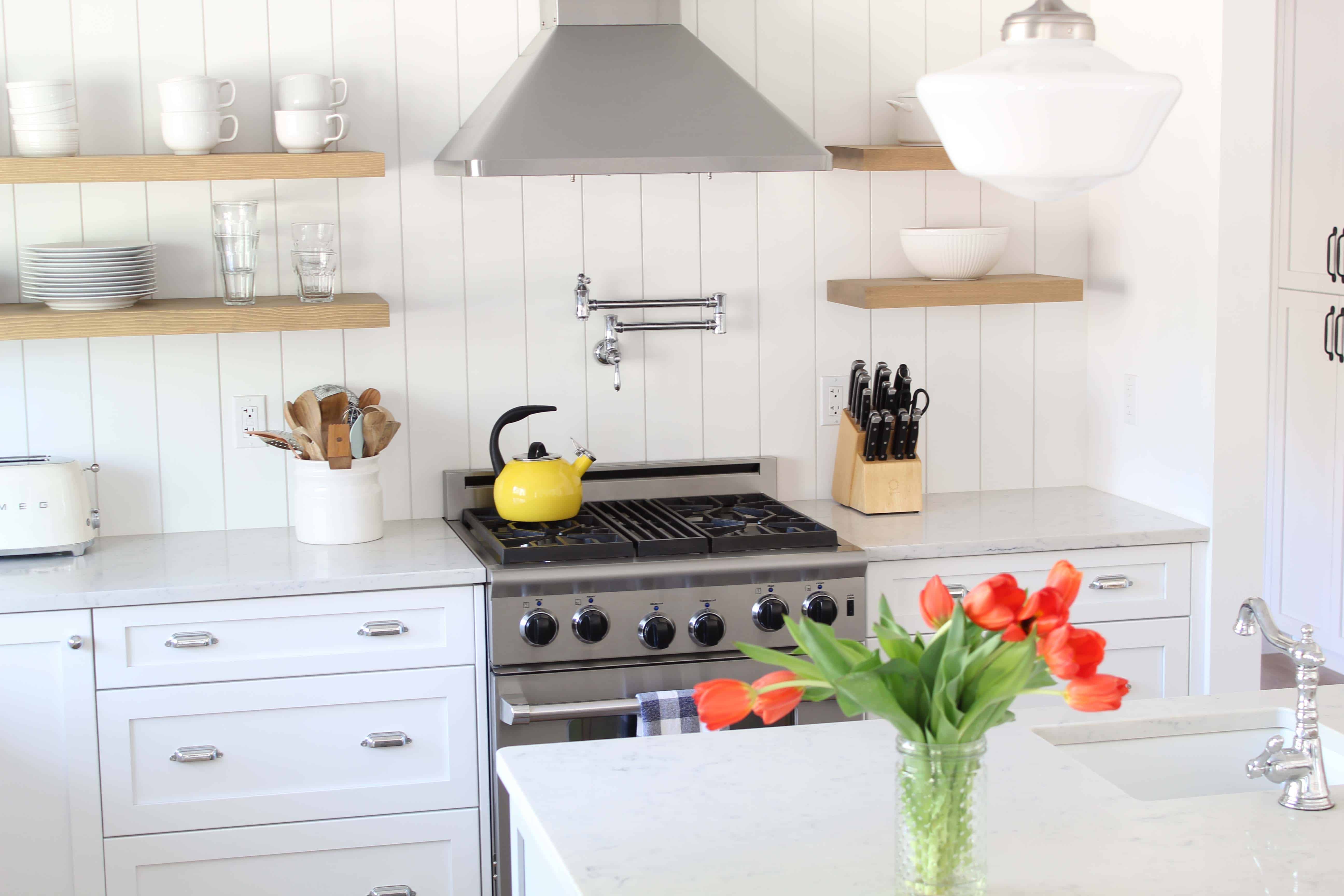 modern farmhouse kitchen with white vertical shiplap backsplash and open shelving