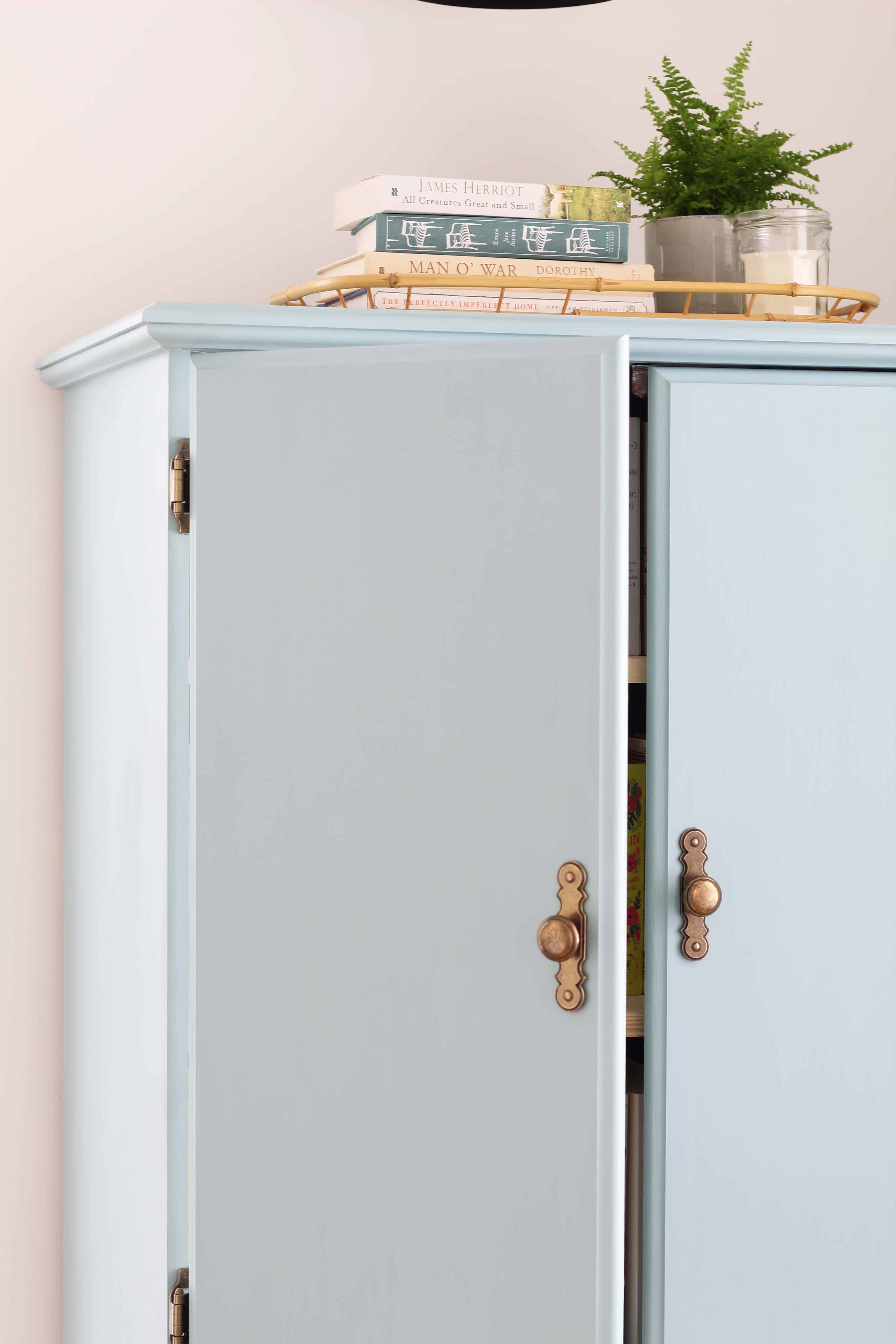 blue chalk paint cabinet with black sconce