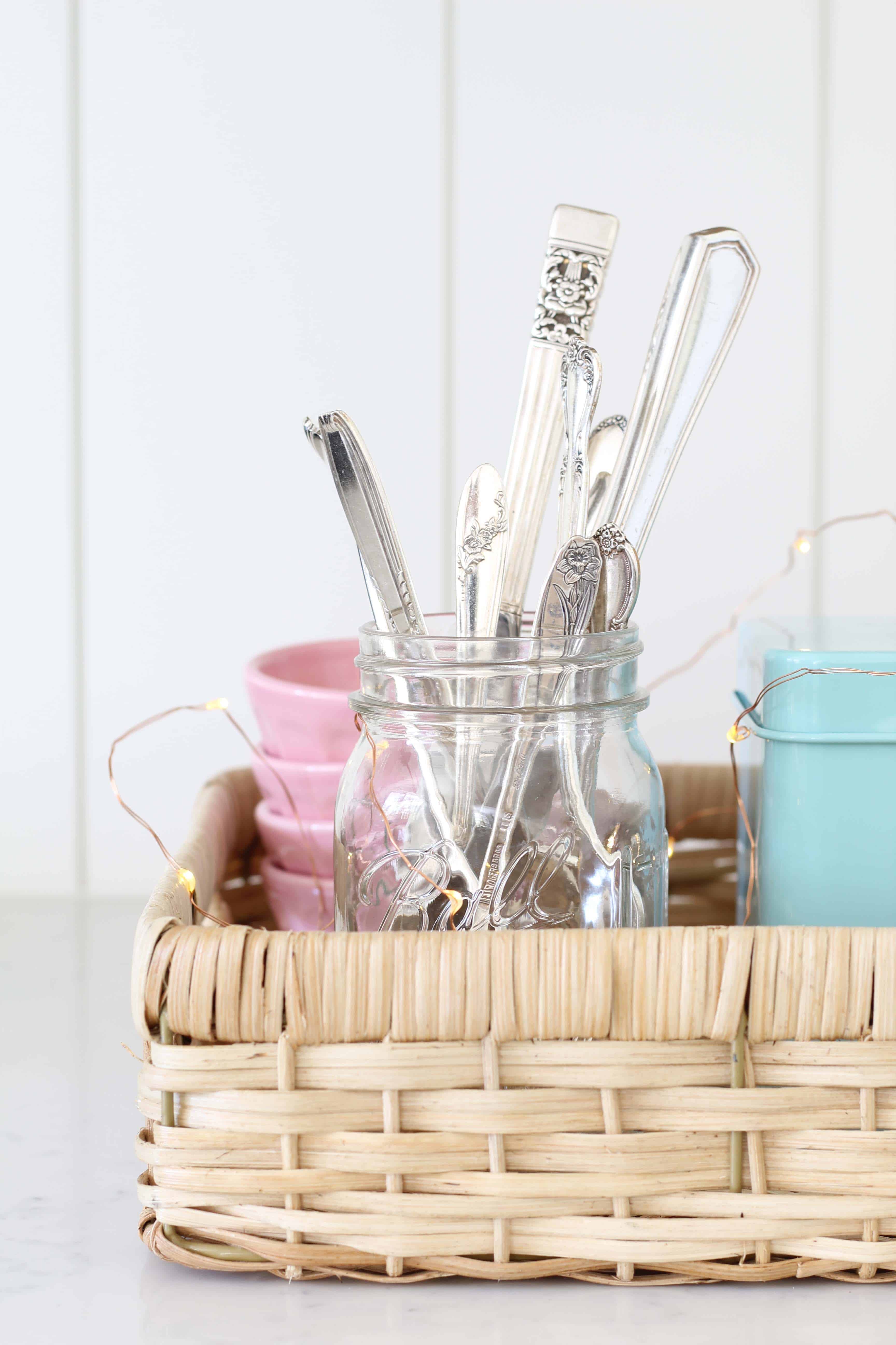 vintage silverware in a mason jar, anthropologie pink mini latte bowls, aqua recipe tin, mini fairy lights