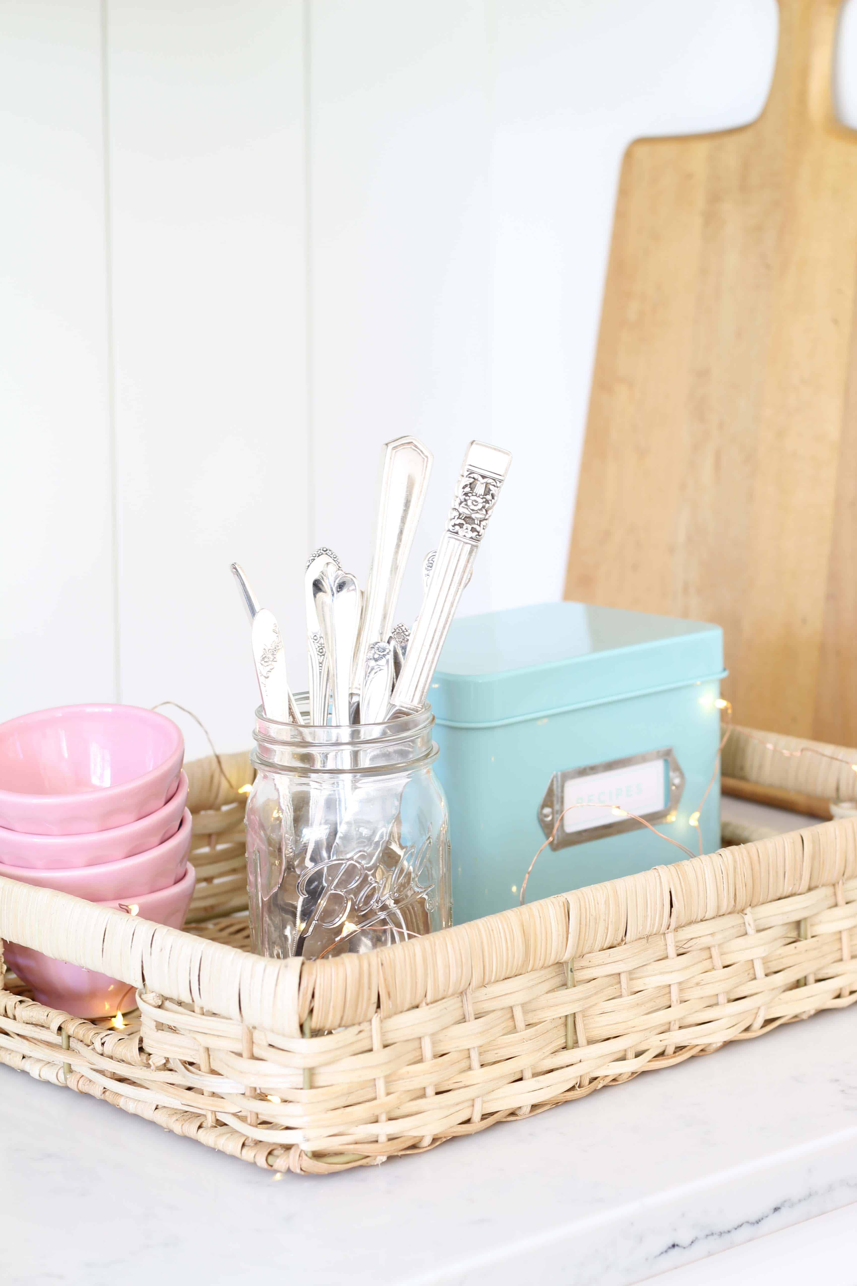 vintage silverware in a mason jar, anthropologie pink mini latte bowls, aqua recipe tin, mini fairy lights