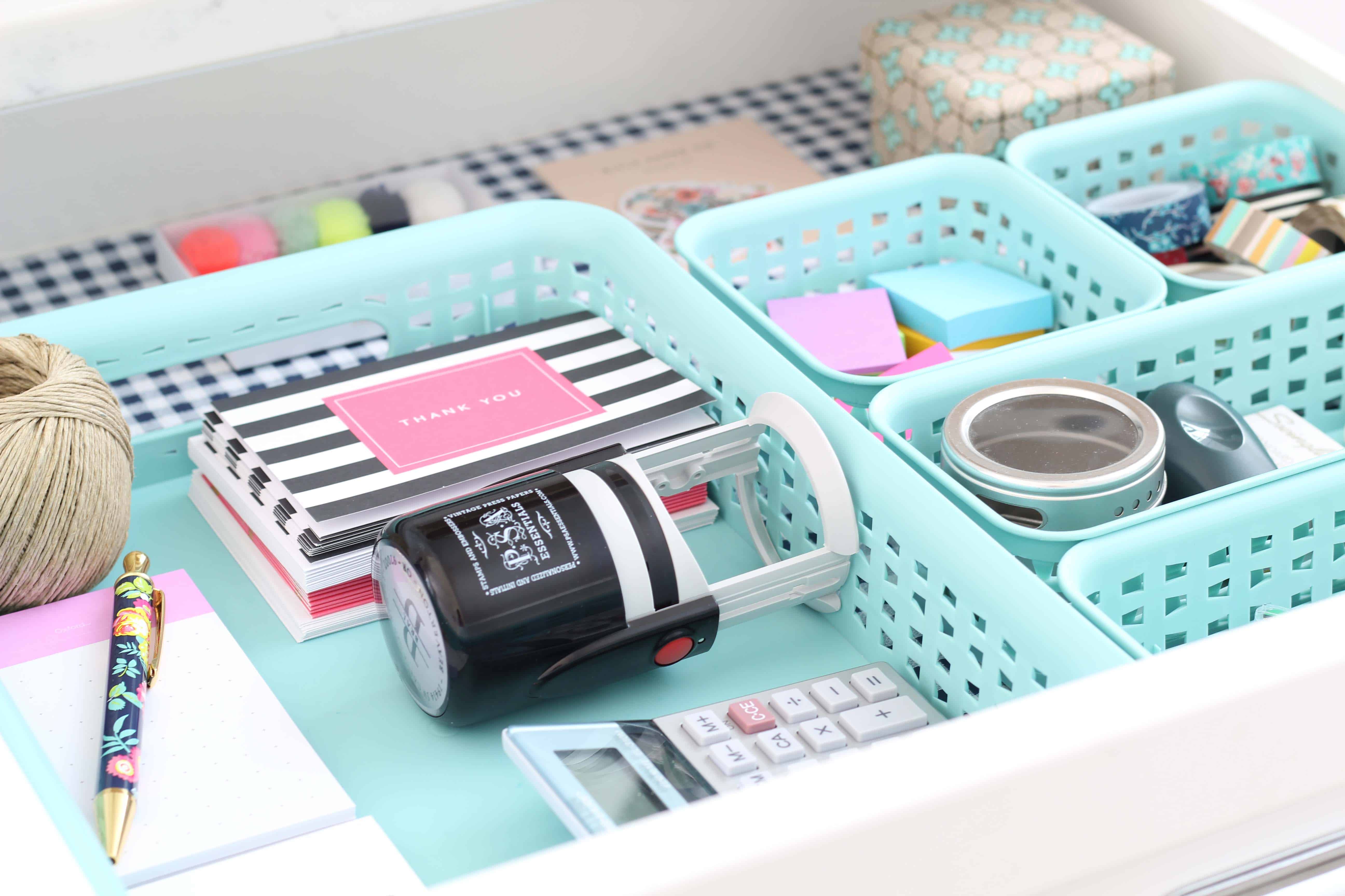 aqua baskets used to organize a junk drawer