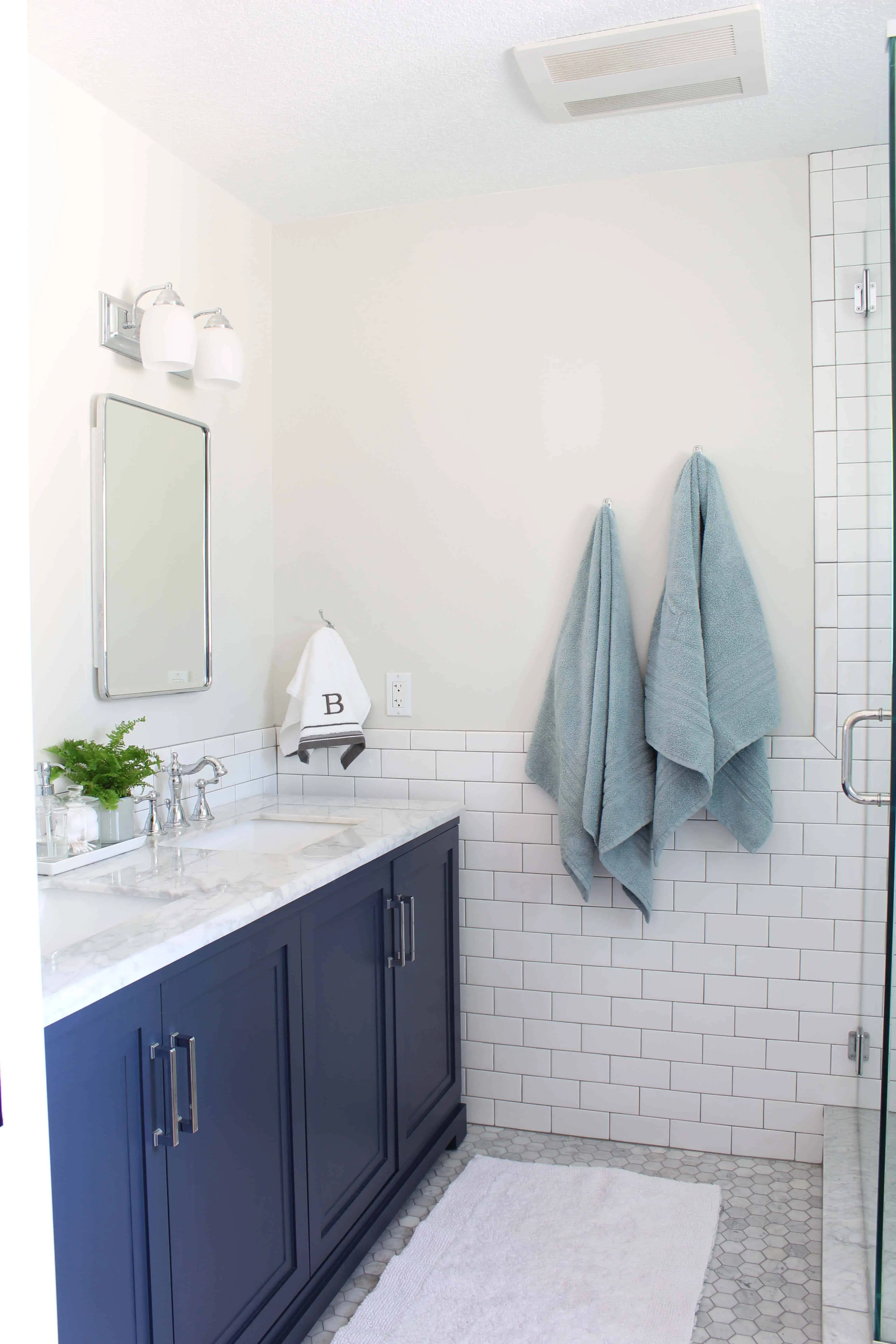 navy blue vanity with white subway tile bathroom 