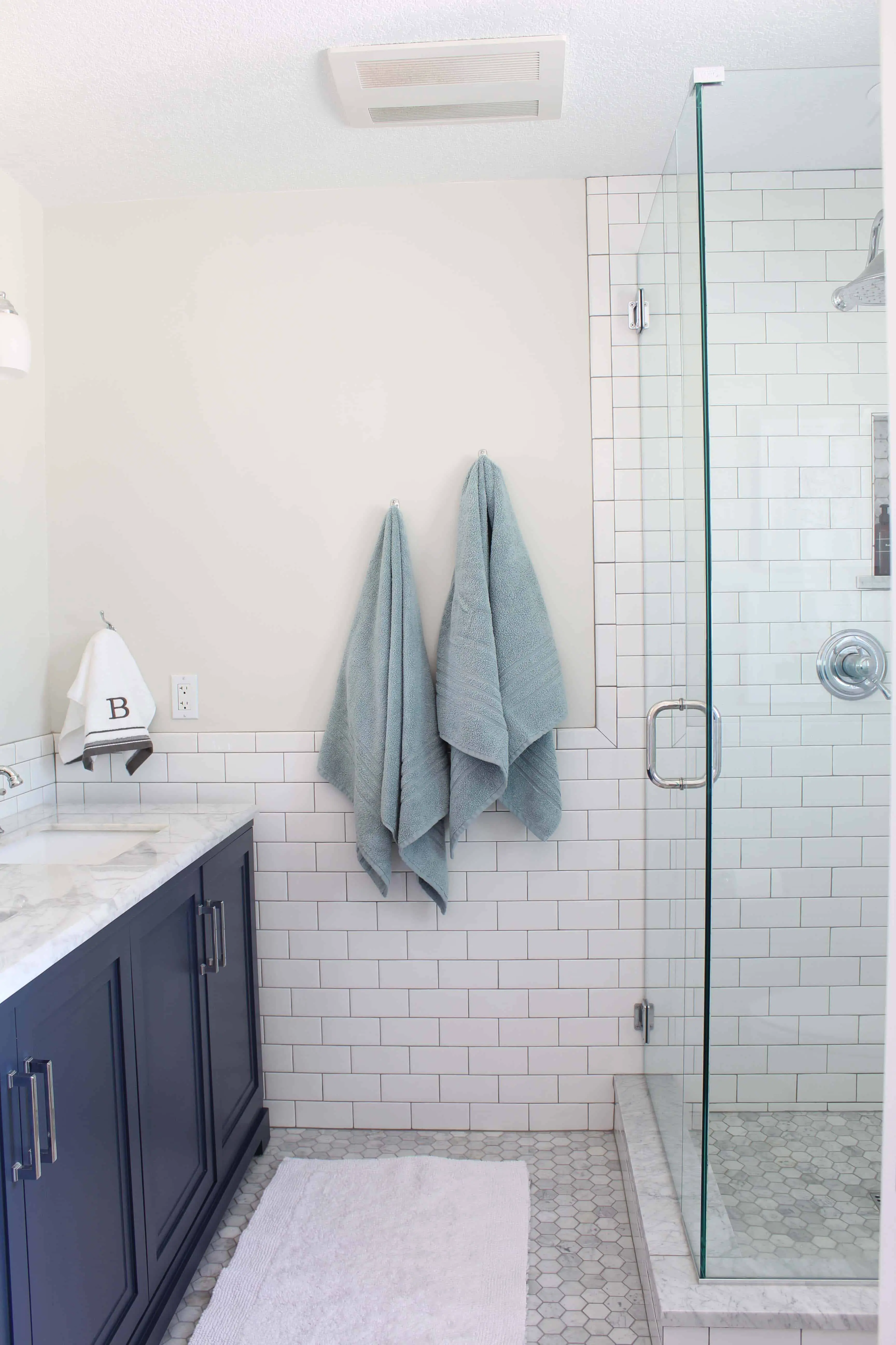 navy blue bath vanity with white subway tile