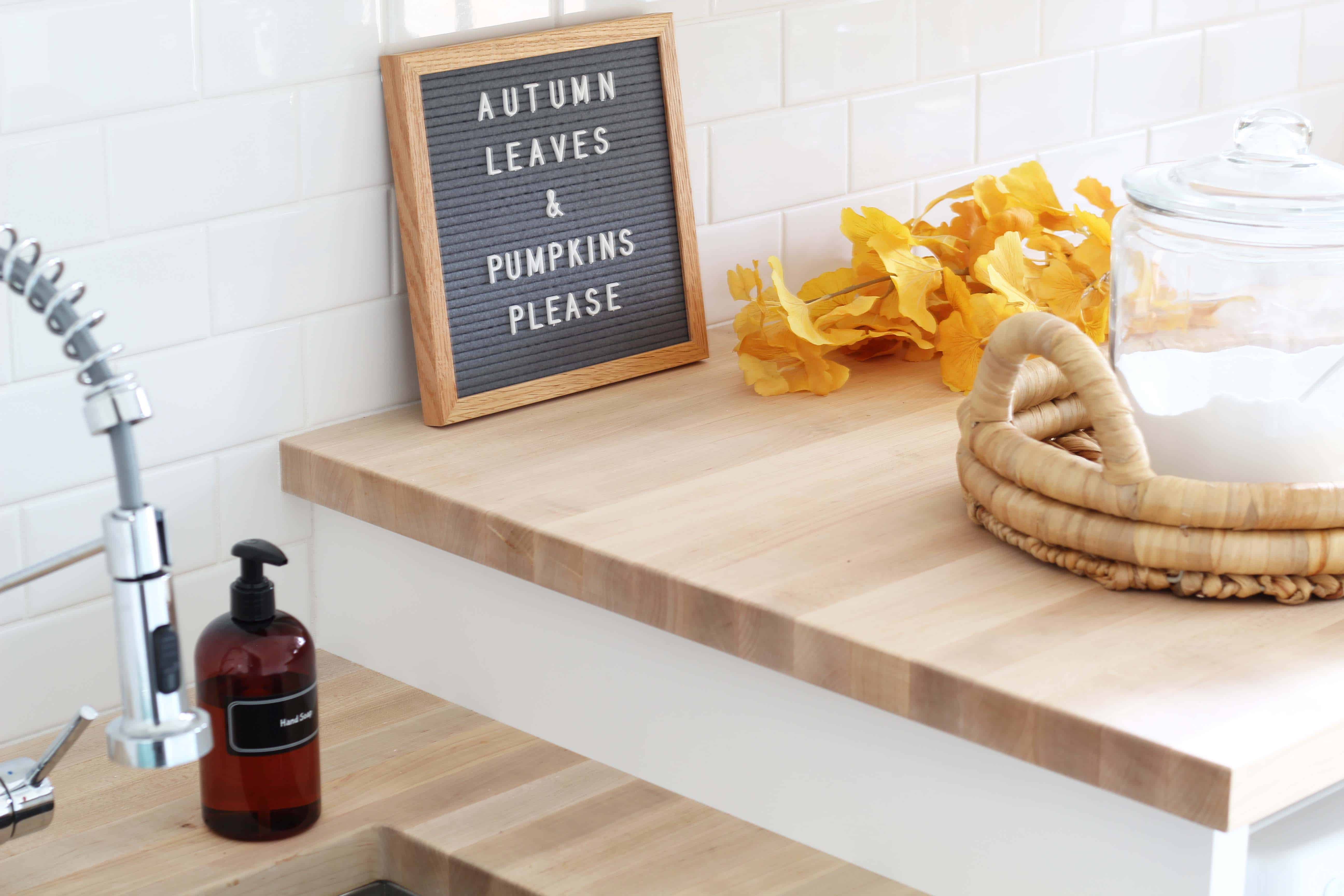 letterfold letterboard, amber soap dispenser bottle, fall gingko leaves, laundry room with butcher block counters