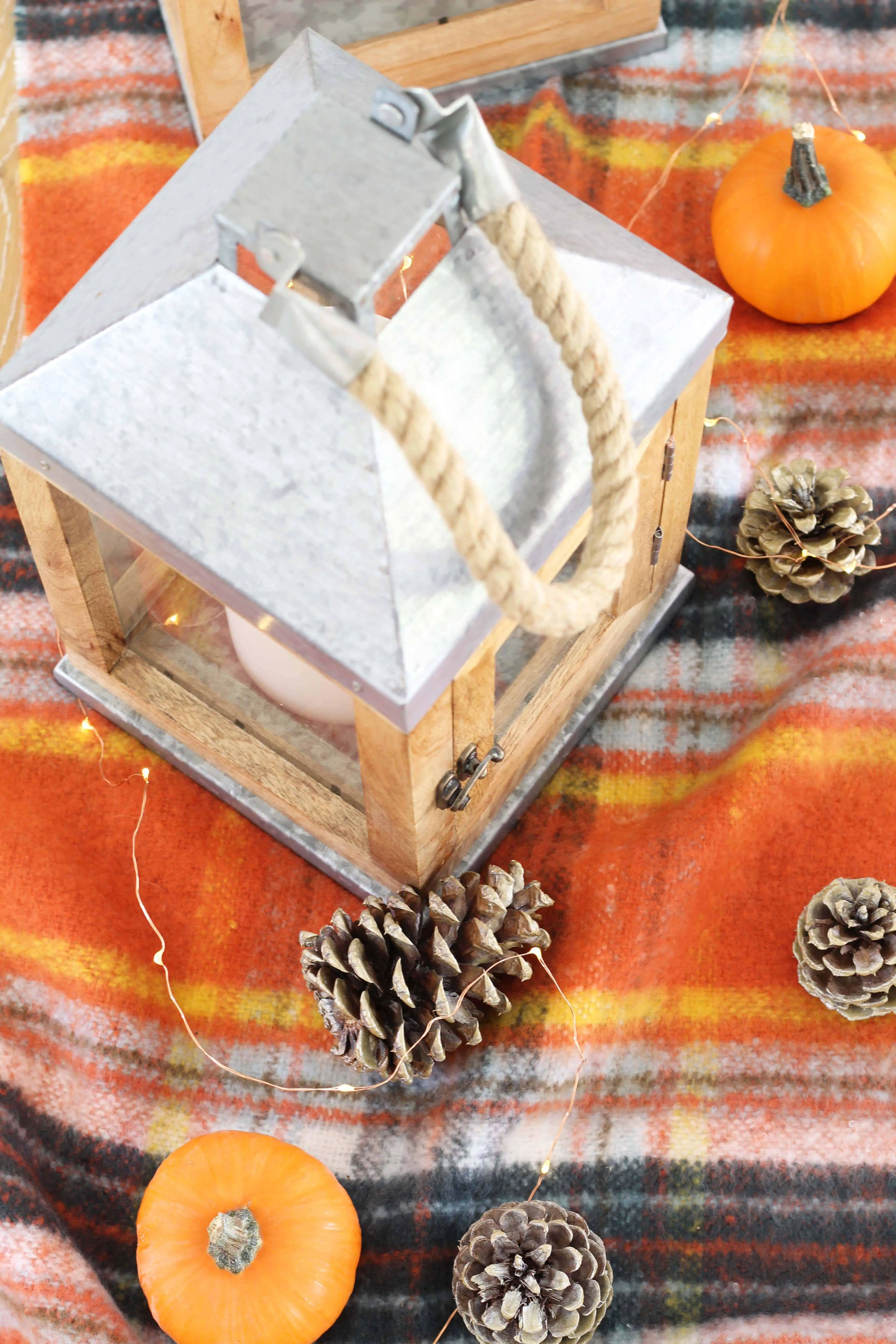pinecones, aerie orange plaid blanket scarf, farmhouse wood lanterns, mini pumpkins