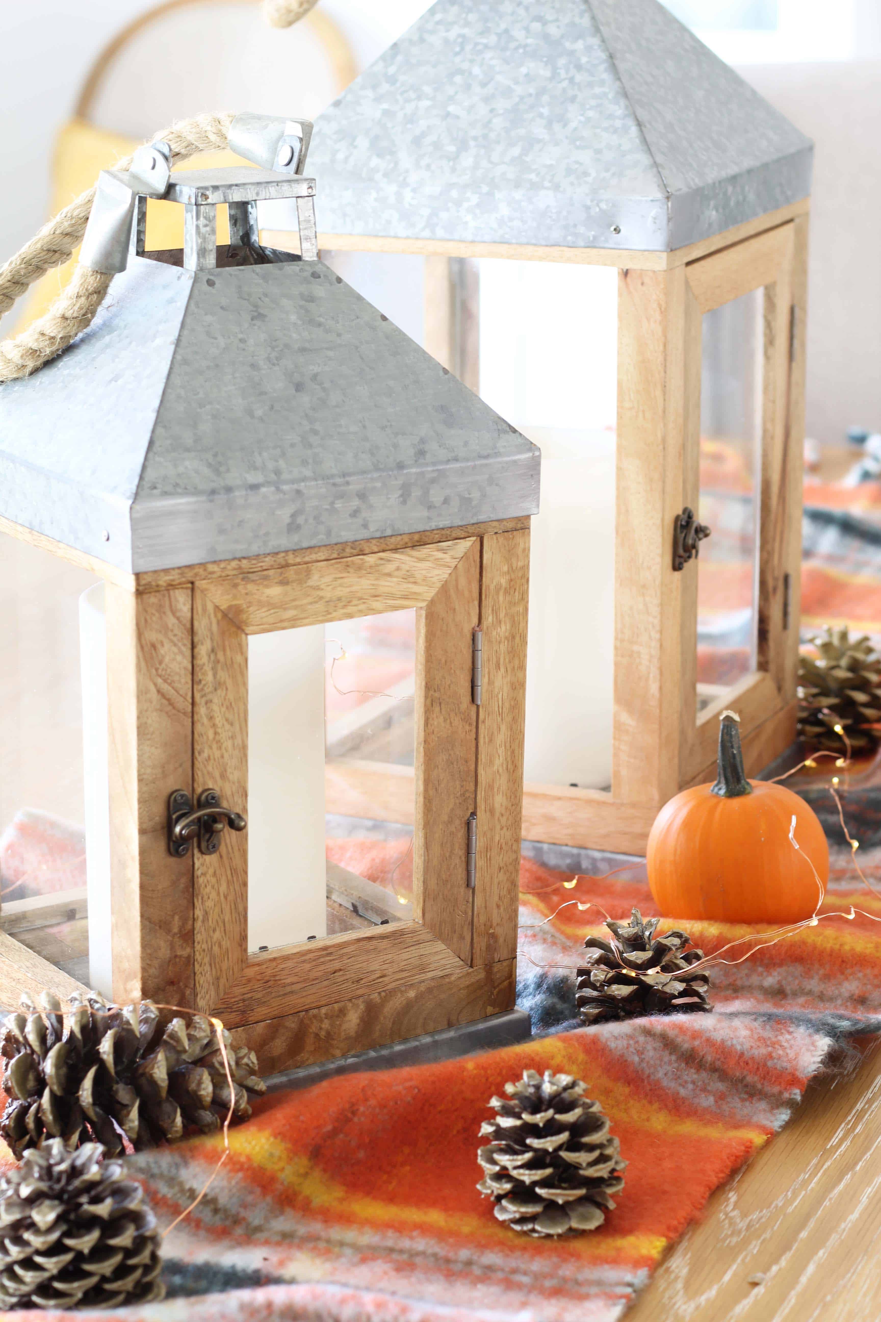 pinecones, aerie orange plaid blanket scarf, farmhouse wood lanterns, mini pumpkins