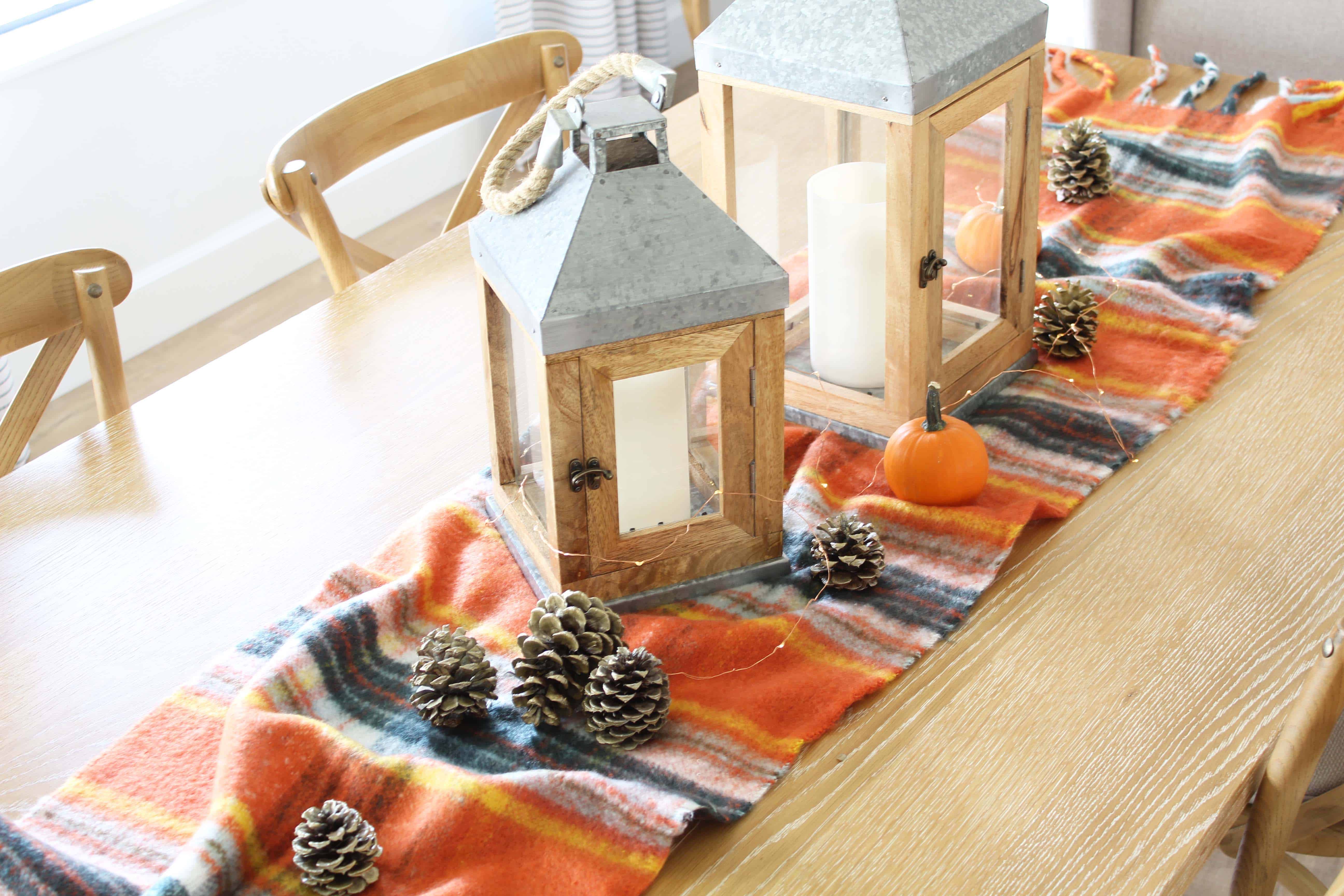 pinecones, aerie orange plaid blanket scarf, farmhouse wood lanterns, mini pumpkins