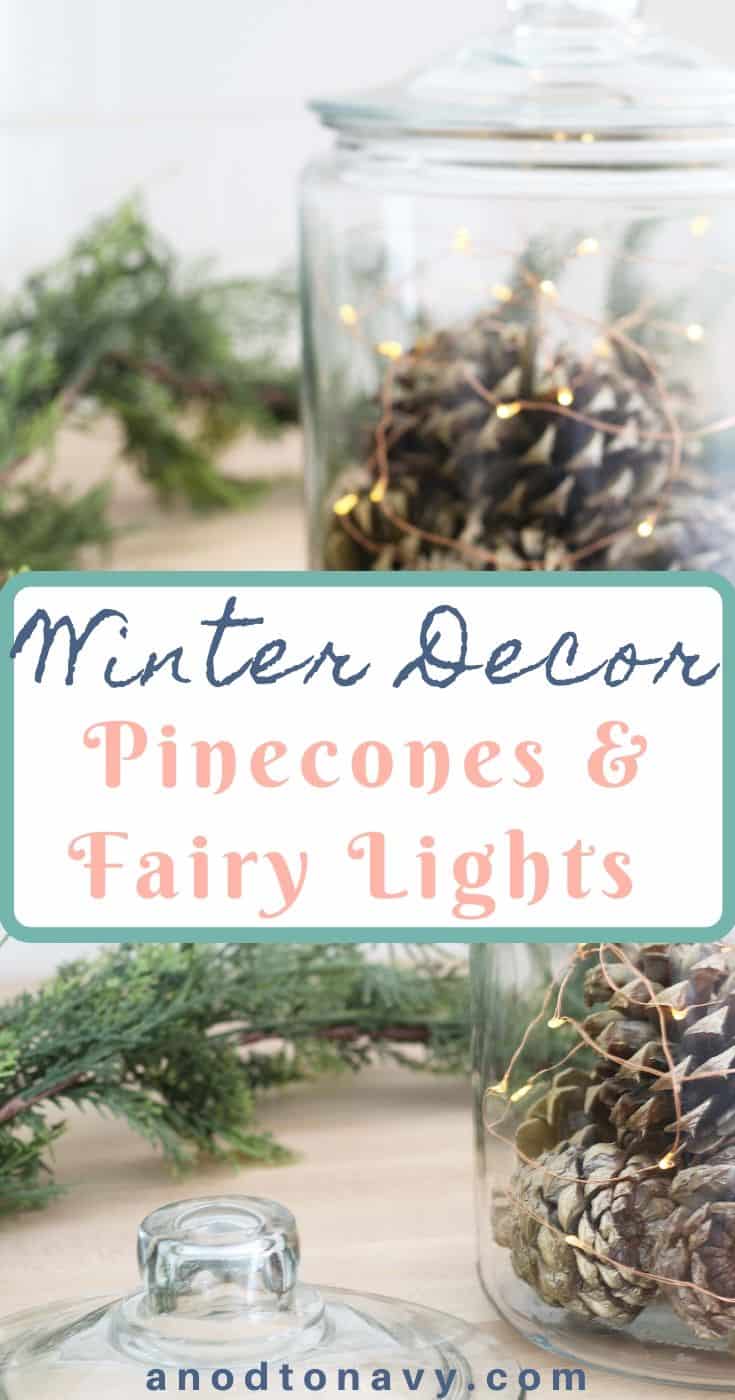 gold pinecones in glass canister with fairy lights