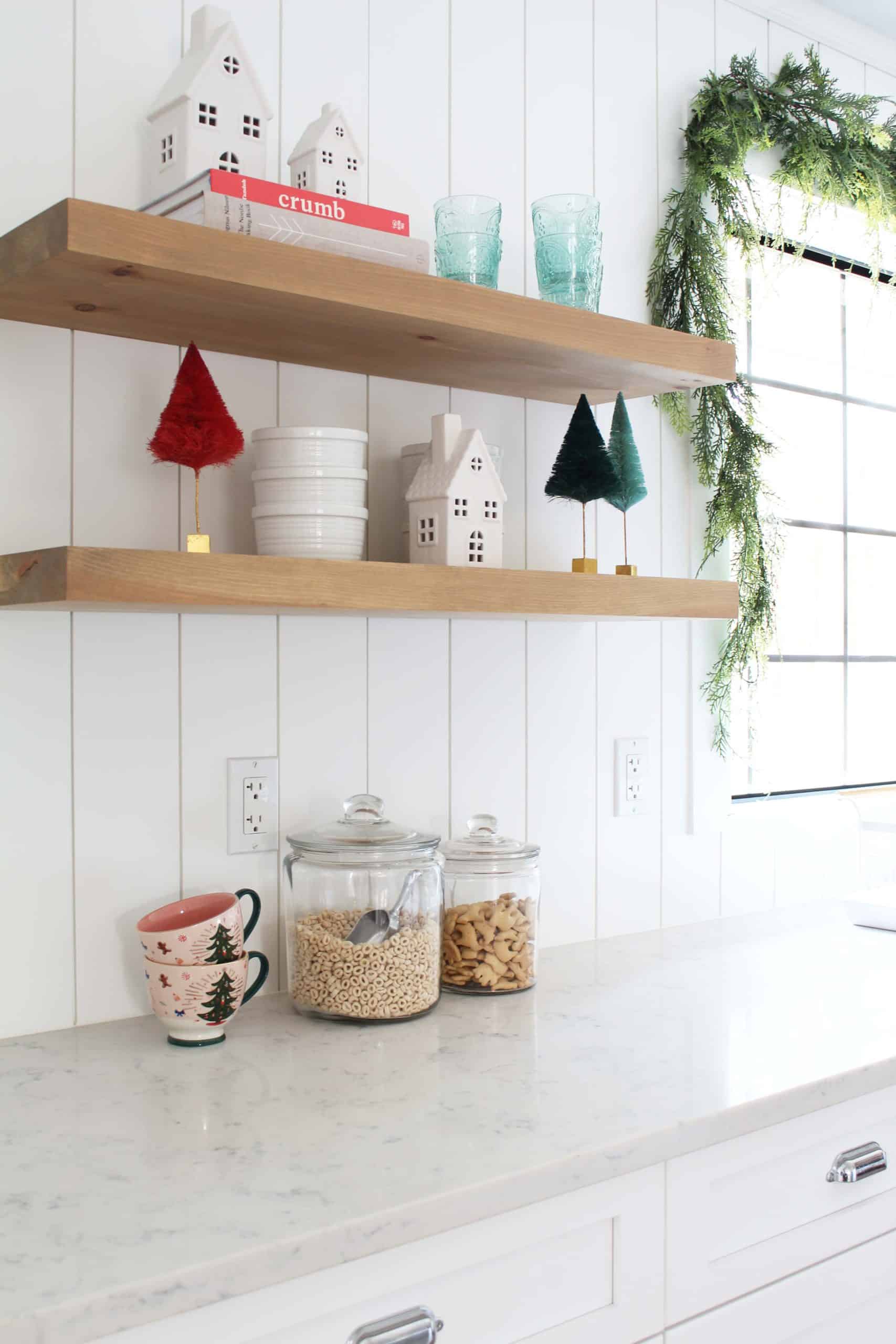 faux cedar garland, glitterville bottle brush trees, rifle paper co. pink christmas tree mugs, target white ceramic christmas village houses