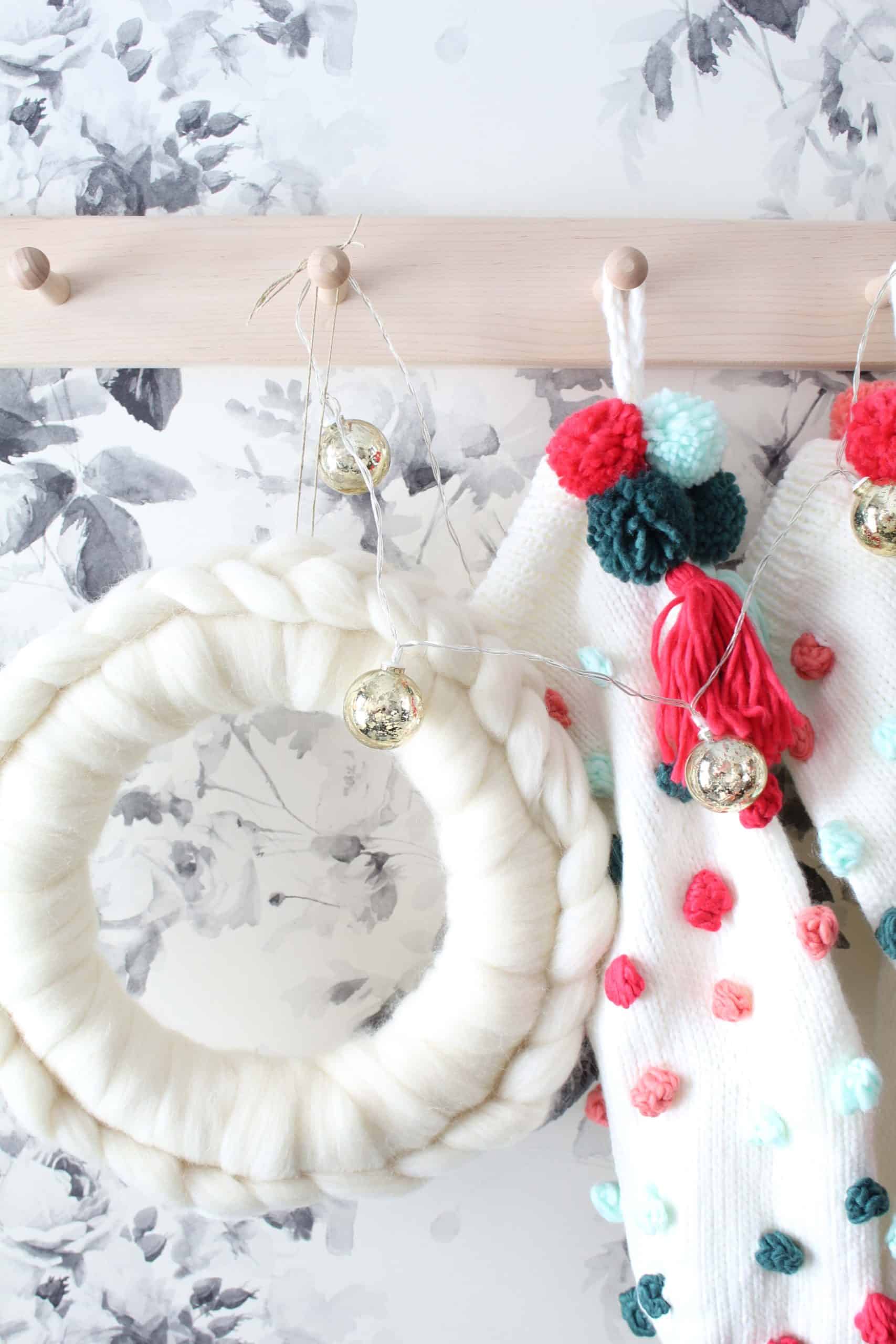 anthropologie white wool wreath, anthropologie christmas wreath, diy anthropologie wreath, anthropologie pom pom christmas stockings, smoky rose wallpaper by house of hackney