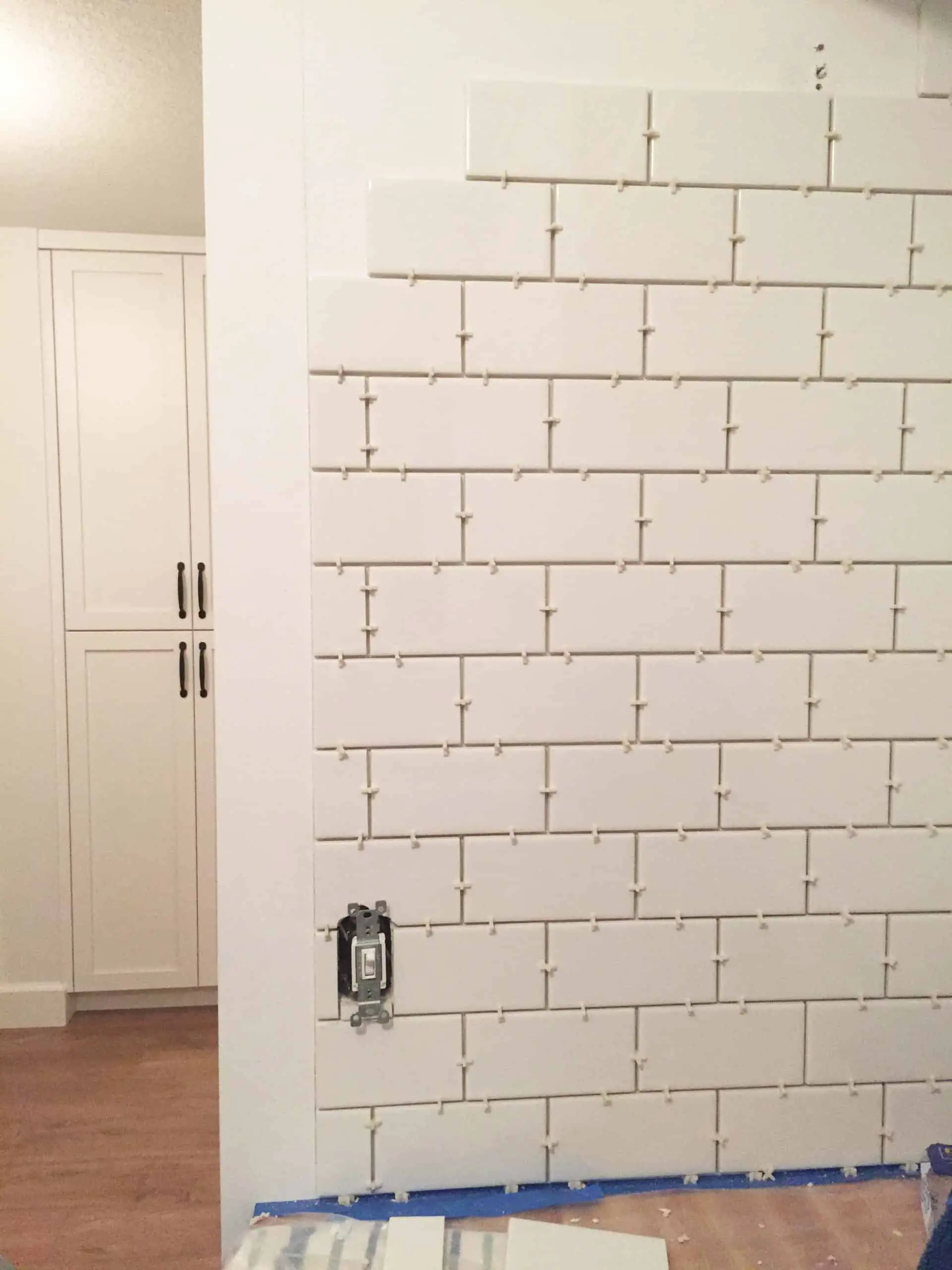 white subway tile backsplash in laundry room with 1/8 inch spacers